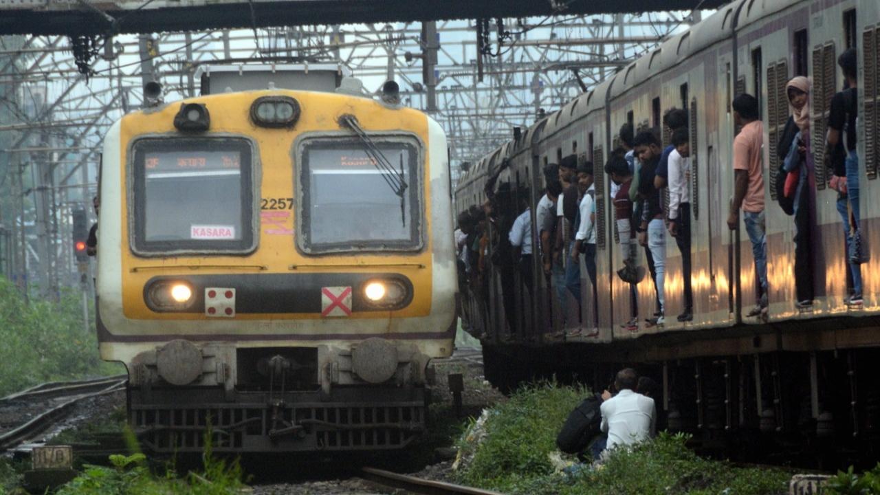 Commuters change trains on track, some even boarded on a board moving train