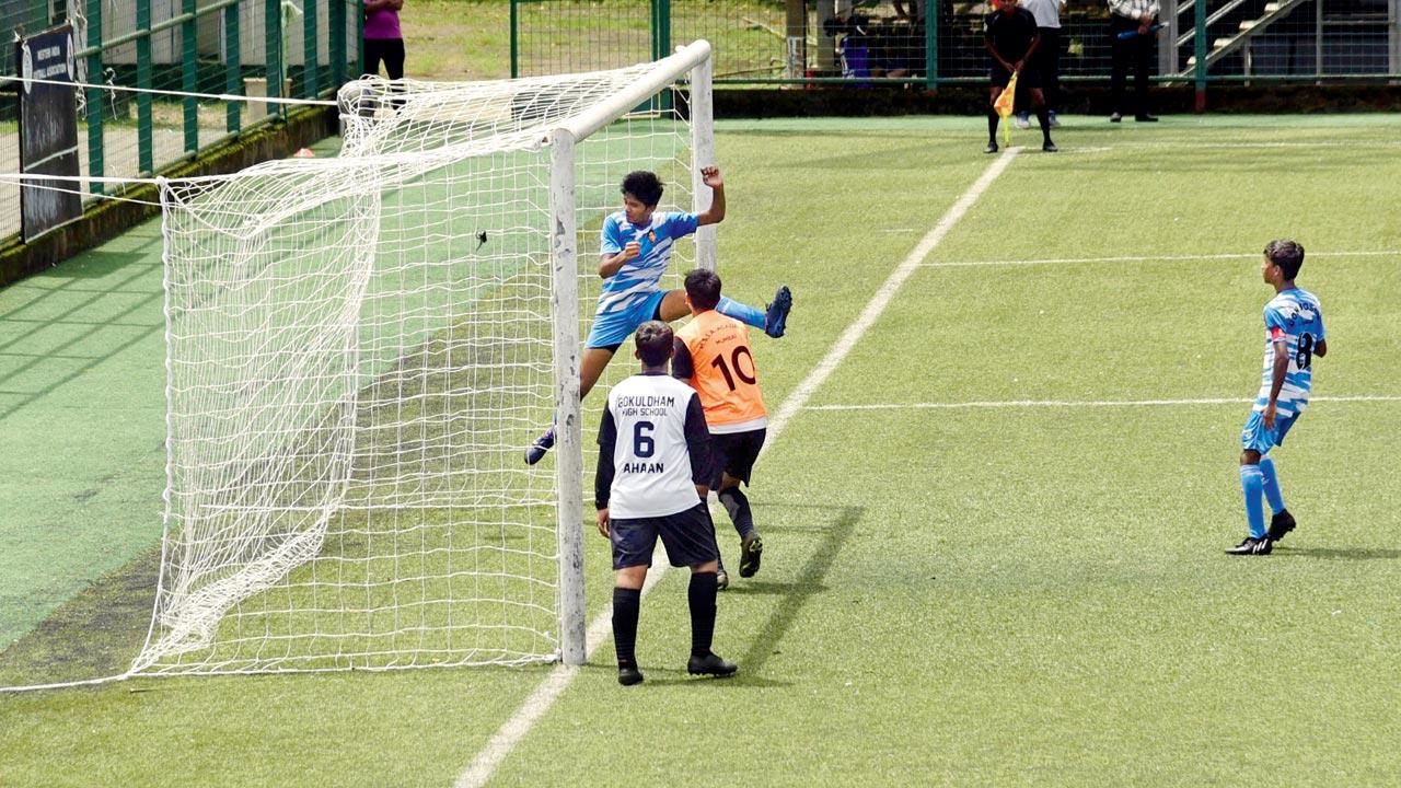 Don Bosco’s Om Kirdat (in blue) scores against Gokuldham HS