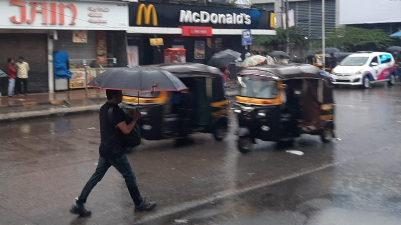 A man walks near Andheri station. The area near Andheri station witnessed waterlogging due to overnight heavy rainfall. Pic/Satej Shinde