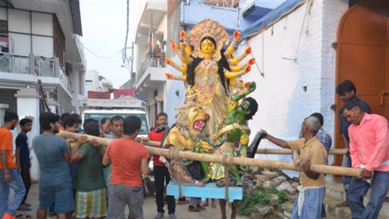 Idol of Goddess Durga being taken to a community pandal in Mirzapur