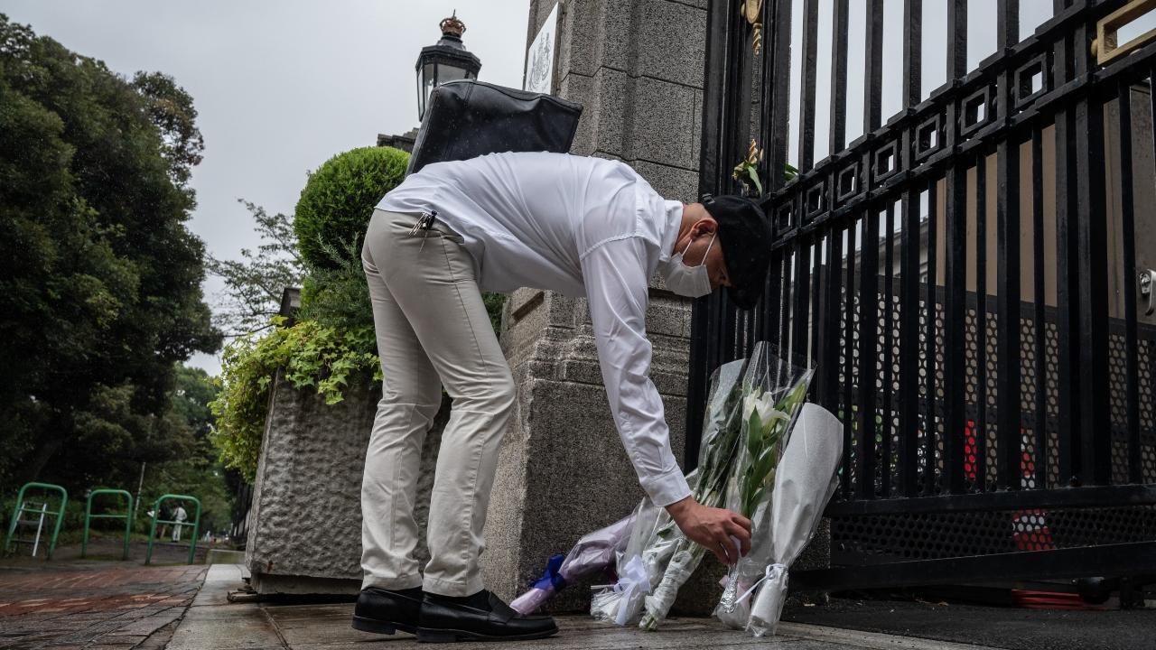 A man lays flowers outside the British embassy following the death of Queen Elizabeth II
