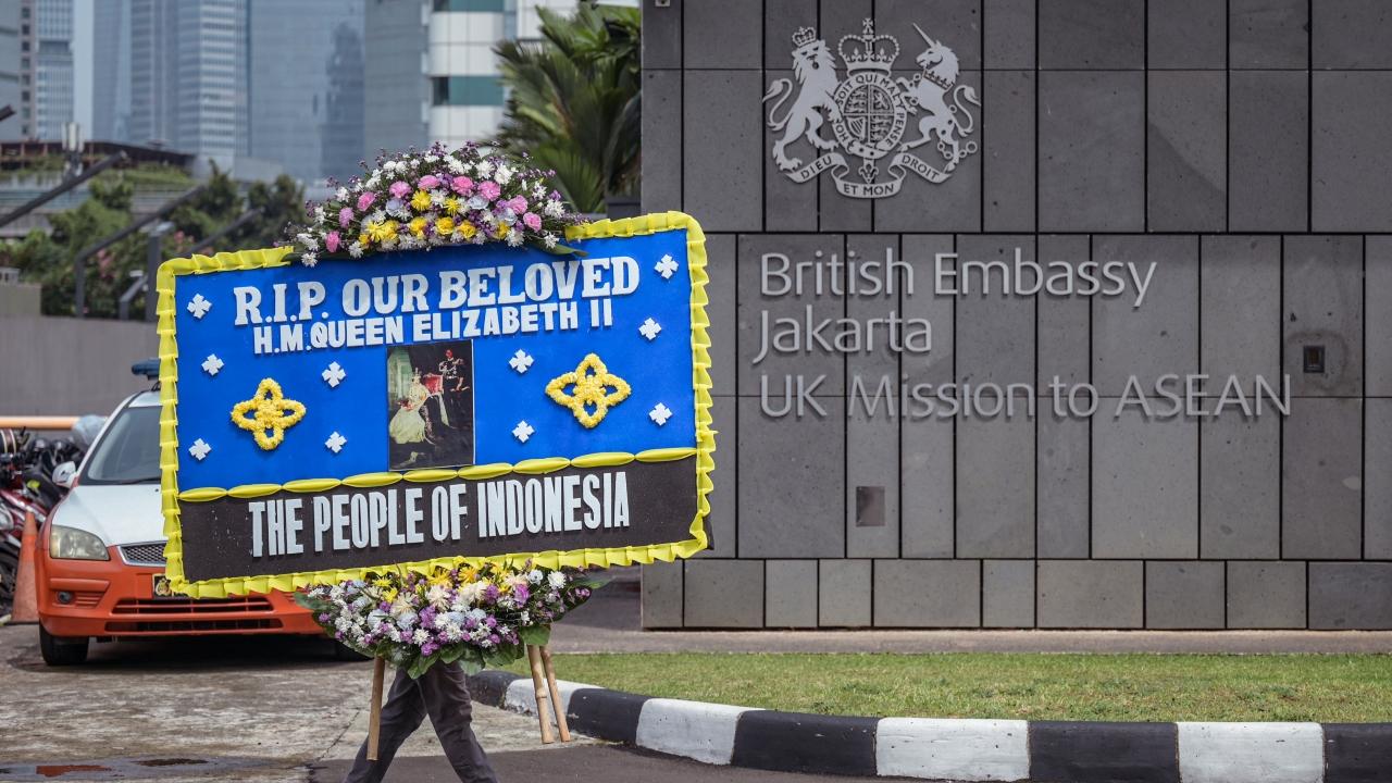 A man delivers a condolence wreath at the British embassy following the death of Queen Elizabeth II, in Jakarta