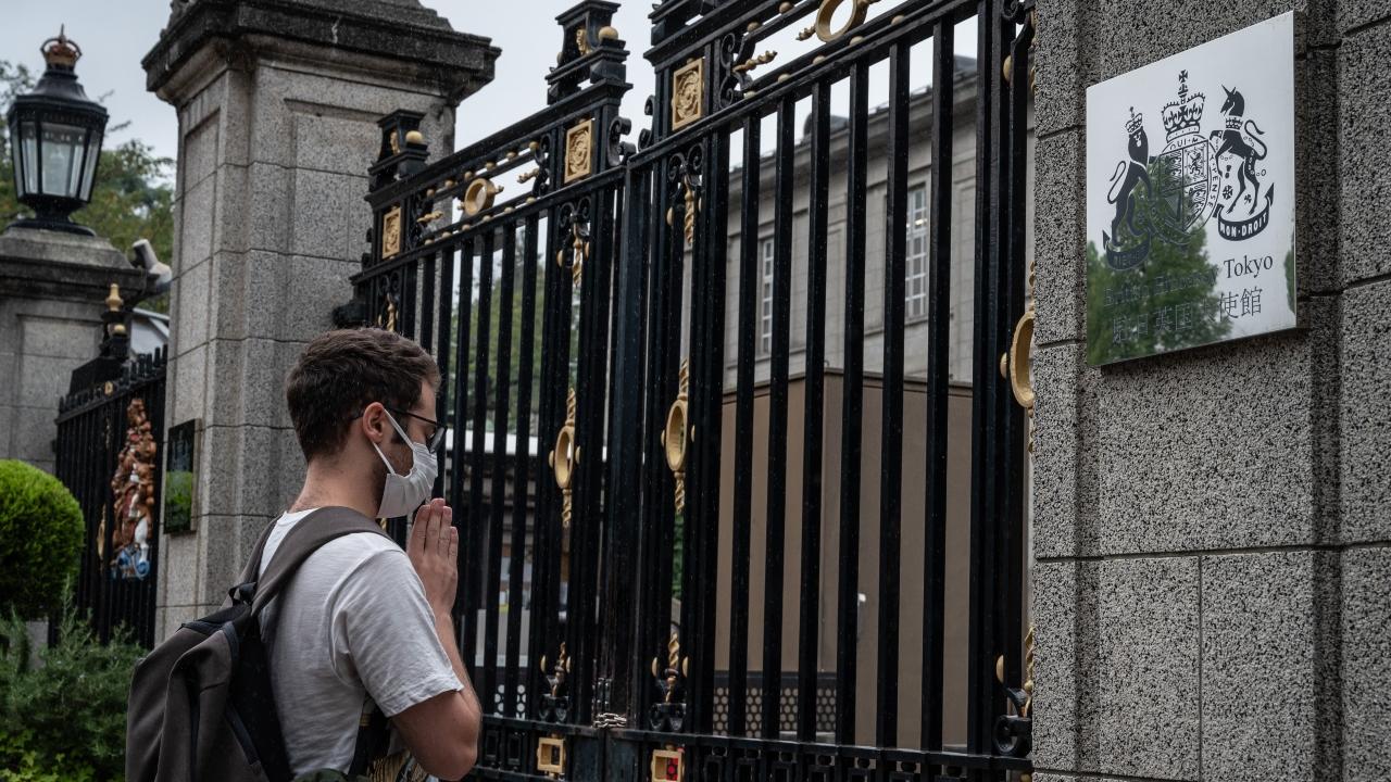 A man prays outside the British embassy following the death of Queen Elizabeth II, in Tokyo on September 9, 2022