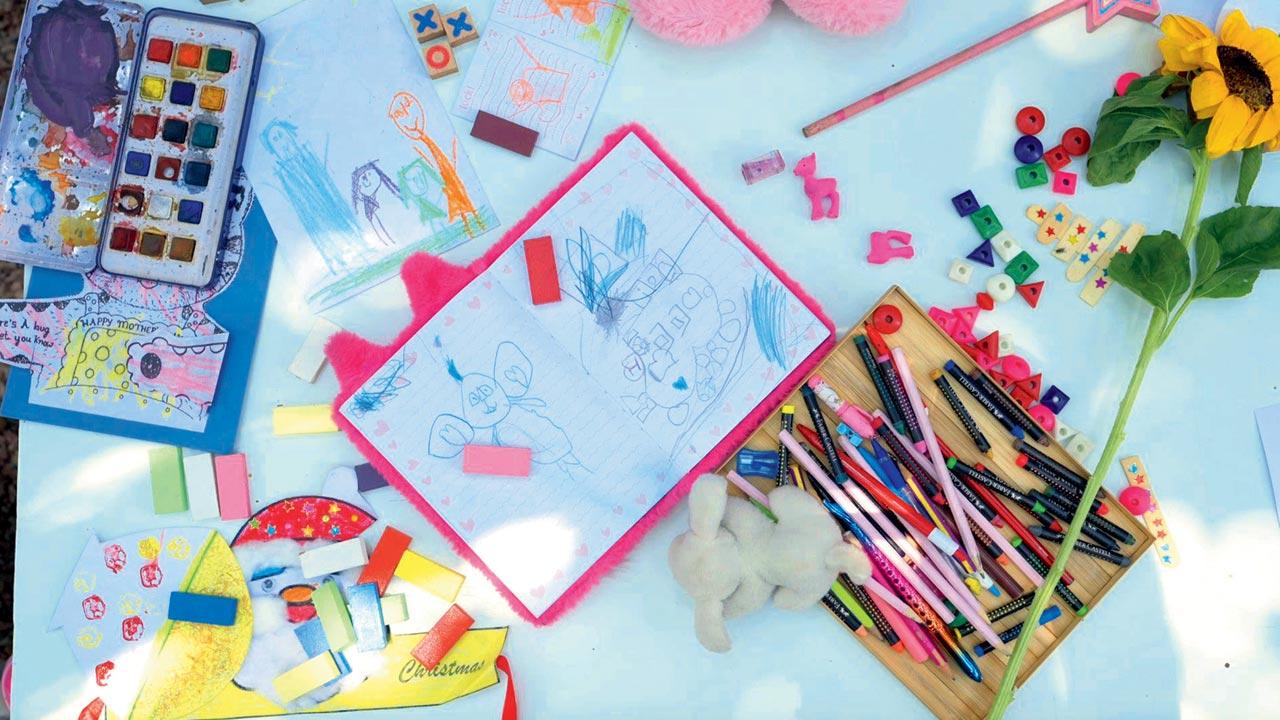 A product prototype by Kala Khoj’s Child Art Project shows drawings and doodles by a child artist surrounded by a pastiche of pouch, tote, shirt and quilt featuring their renditions