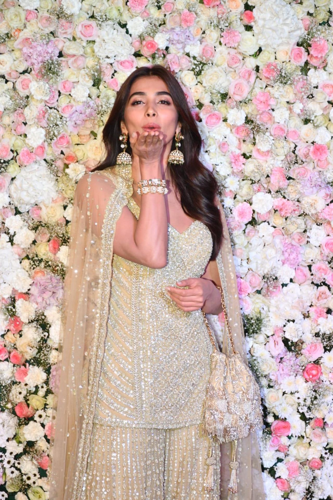Pooja Hegde gave a flying kiss to the paps as she arrived for the party. She stunned in a green Indian wear