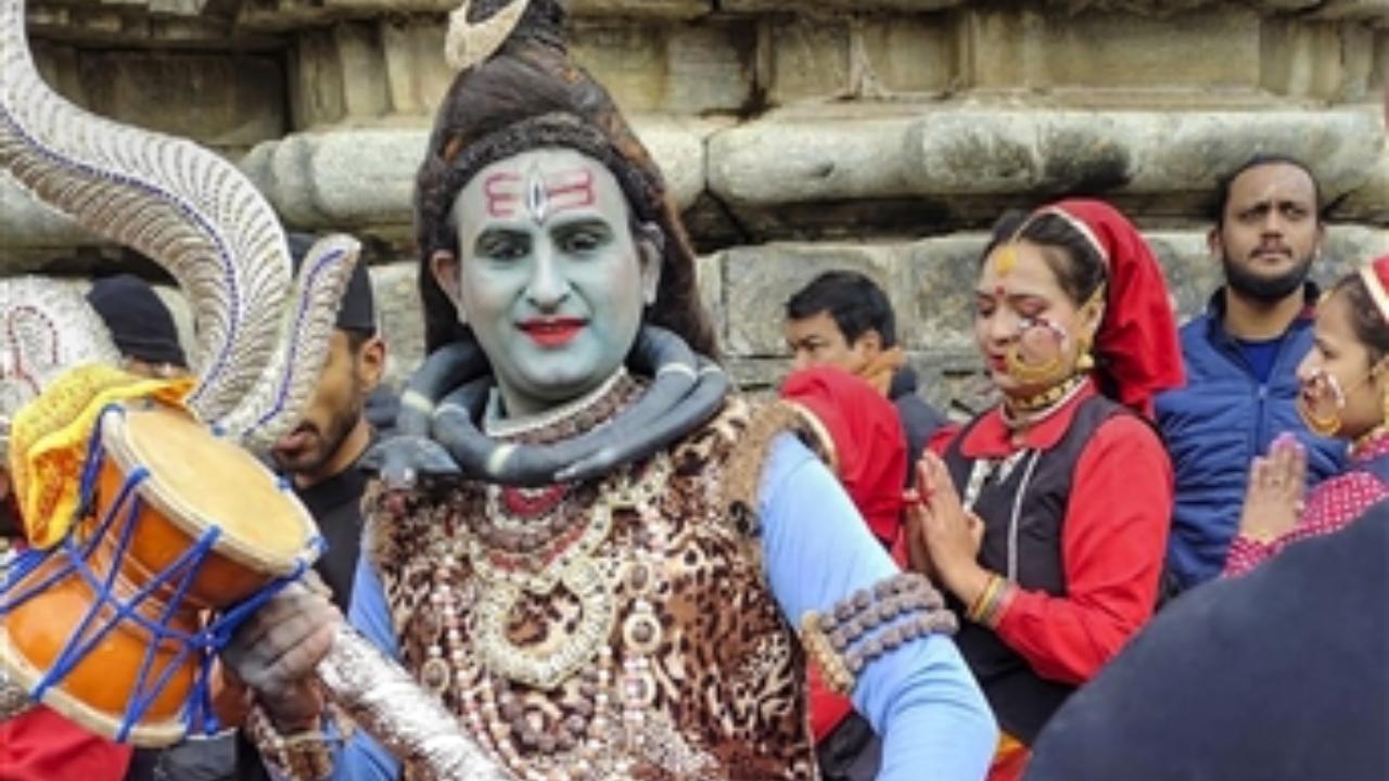 A devotee dressed up as Lord Shiva arrives at the Kedarnath Temple after its portals opened marking the start of the 'Char Dham Yatra', in Kedarnath