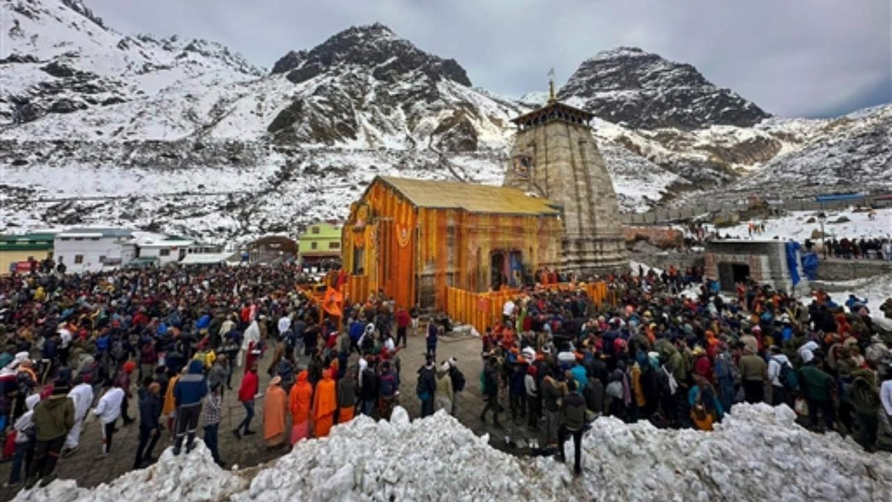 Devotees arrive to offer prayers at the Kedarnath Temple after its doors opened marking the Char Dham Yatra, in Kedarnath