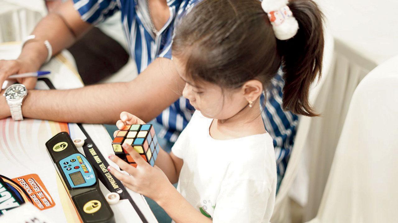 A child solves a Rubik’s Cube at the  weekend session