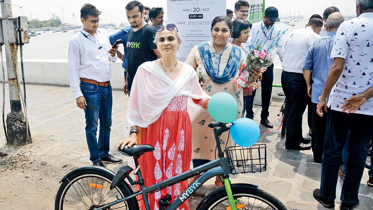 Local Bella Shah stands with a bicycle