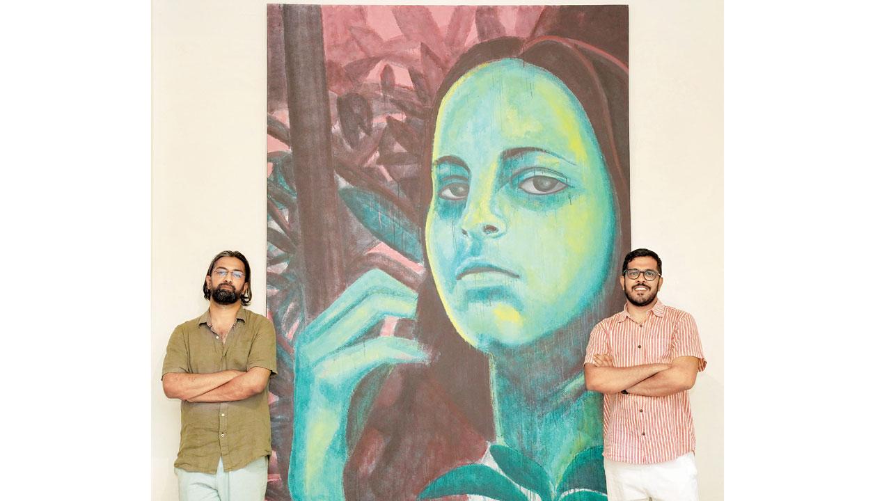 Curator and artist Amitabh Kumar with Joe Cyril, director and CEO of Gallery XXL in Colaba, in front of Anpu Varkey’s piece for which she has used the paint drip technique