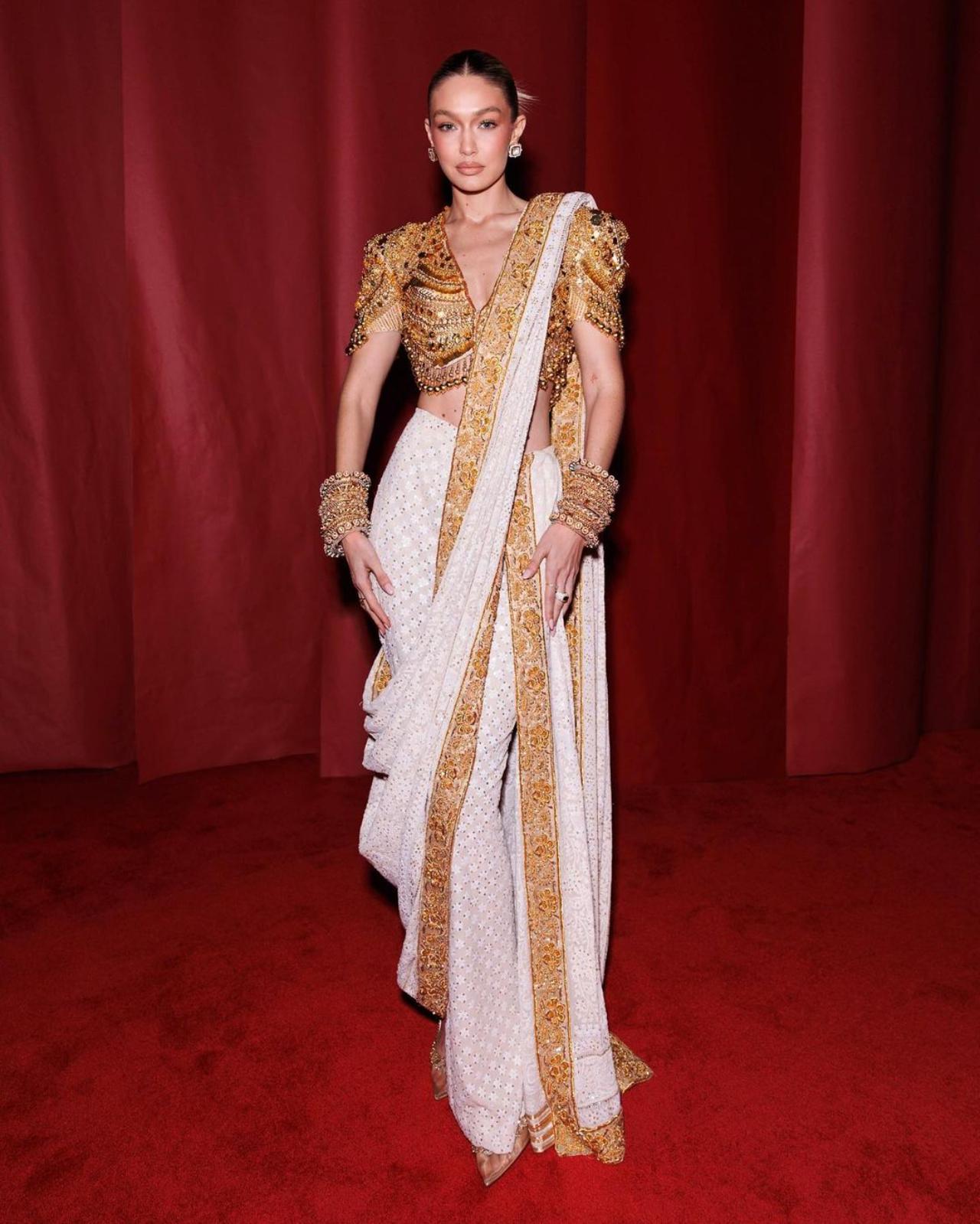In her first trip to India, Gigi Hadid made a statement in a white and gold saree by Abu Jani Sandeep Khosla. The Chikankari sari was made in the Lucknow region of India, and took a year to make. Wach woman who crafted it specializes in a different stitch, shared Gigi while sharing pictures from the event