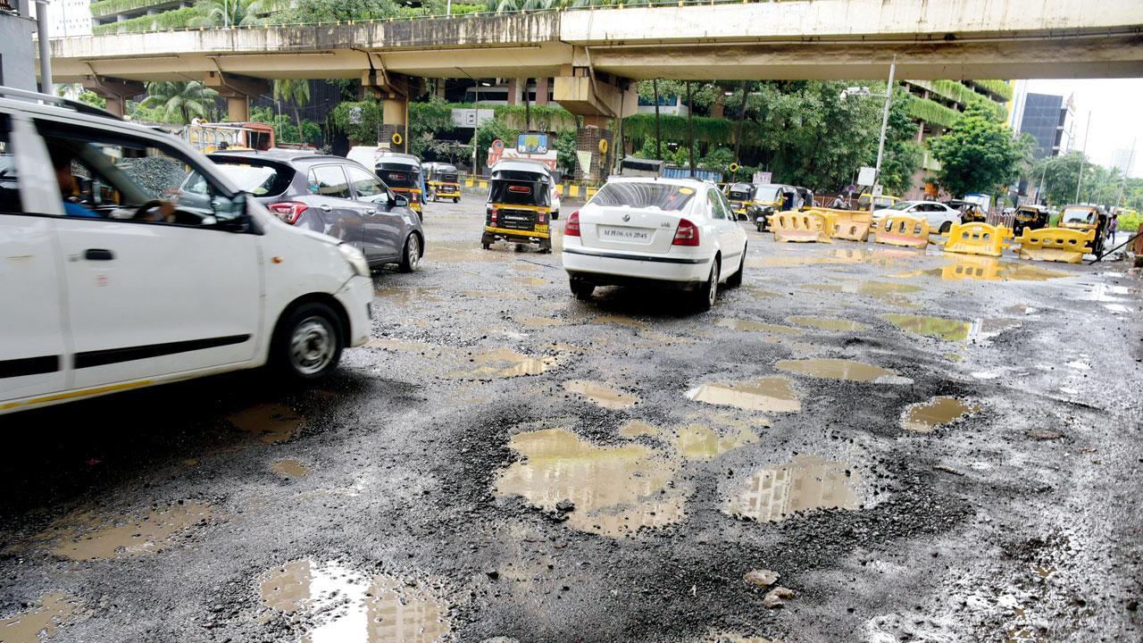 Potholes on the road below Mrunal Gore flyover bridge in Goregaon. File pic/Atul Kamble