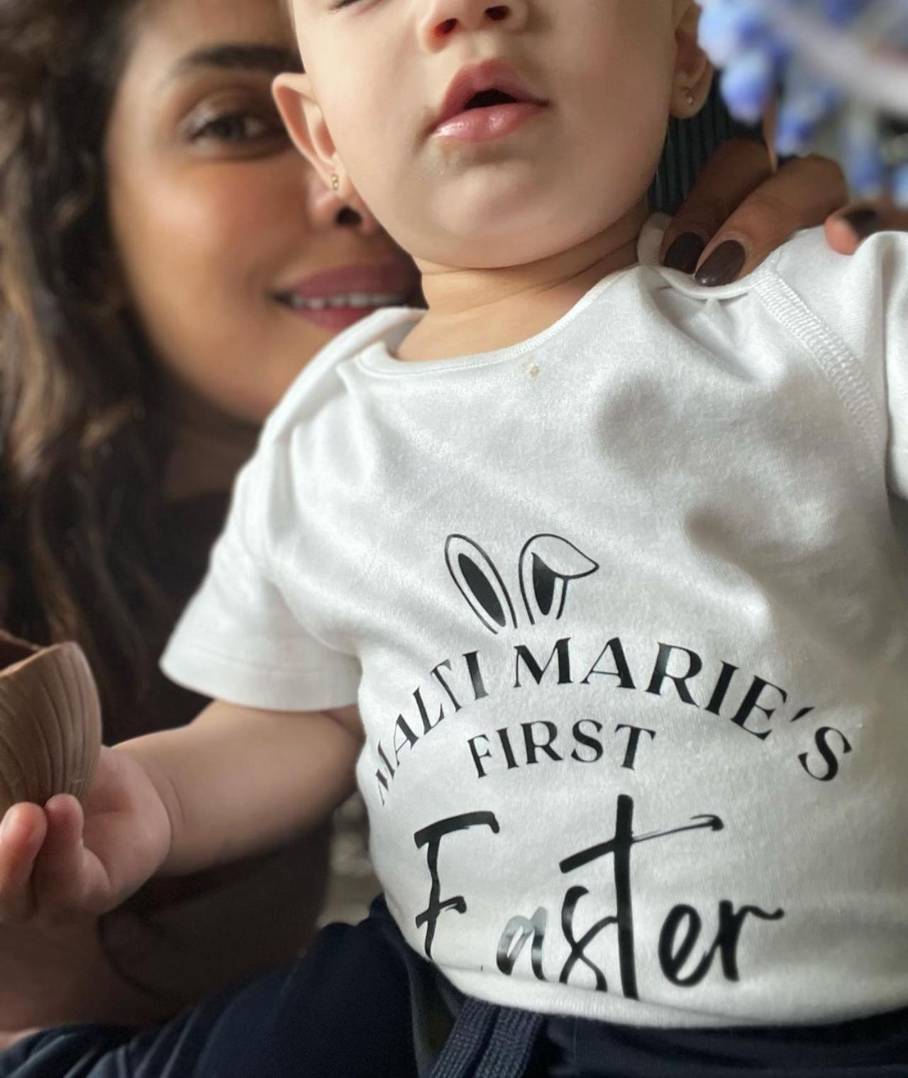 Priyanka Chopra Jonas took to her Instagram feed to share glimpses from her daughter, Malti Marie Chopra Jonas`s first Easter celebration. She shared multiple pictures of the little one enjoying the festivities. In the pictures, Malti Marie is seen wearing a white T-shirt that reads: `Malti Marie`s first Easter`