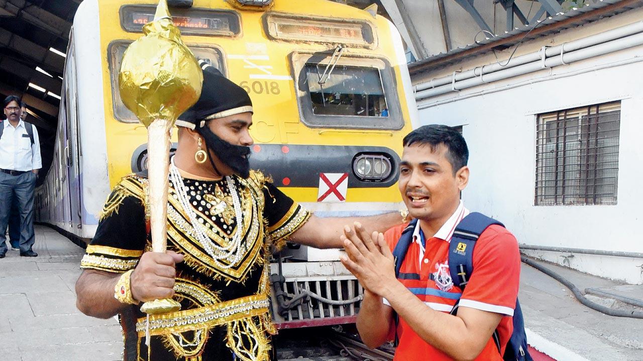 RPF constable Karambir Dahiya dressed as Yamraj goes after errant commuters, as part of the Zero Deaths Mission, aimed at minimising fatalities at railway stations in the city. Pics/Sameer Markande