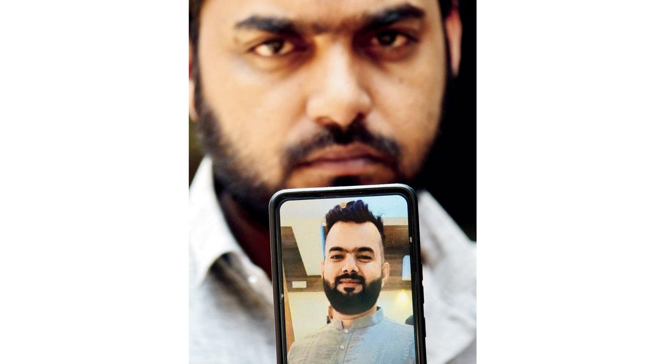 Zahid, Usmani’s brother, shows a picture of him. Pics/Nimesh Dave