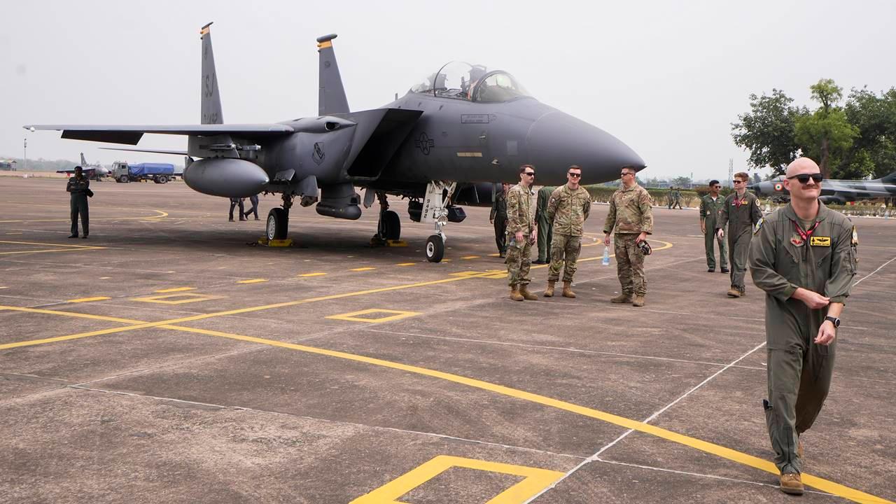 Commanding Officer of a fighter squadron of United States Air Force Lt. Colonel Bender Gifford (right) stands next to an F-15 Eagle fighter jet.