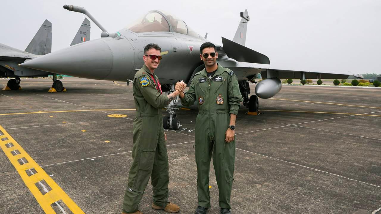 An Indian Air Force (IAF) personnel and a United States Air Force personnel pose next to a Sukhoi Su-30 fighter jet.