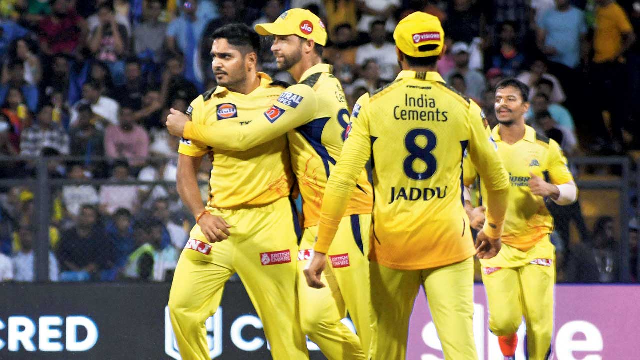 Tushar Deshpande (left) is delighted after picking up a wicket