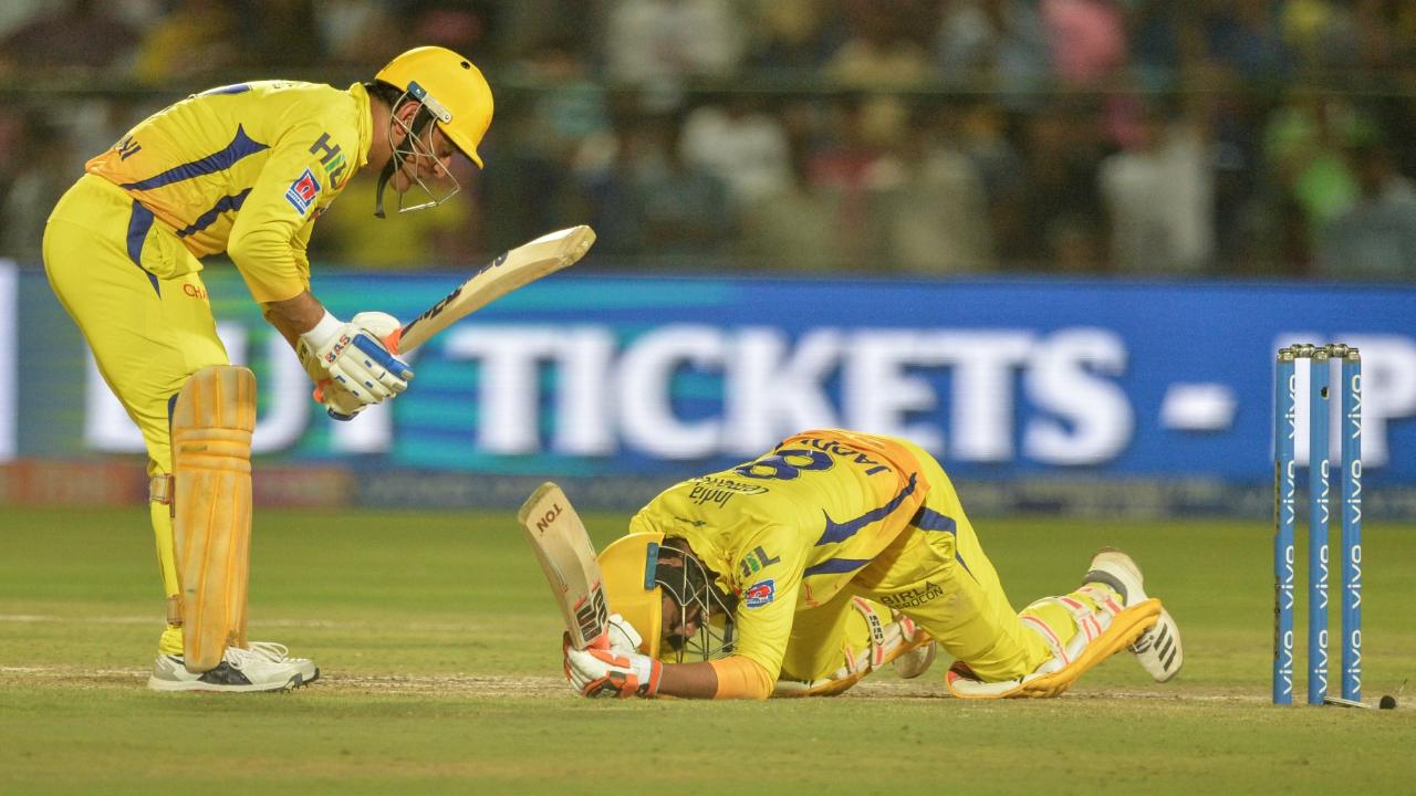 Ravindra Jadeja falls after playing a shot as captain MSD gestures toward him during 2019 IPL match between Rajasthan Royals and Chennai Super Kings
