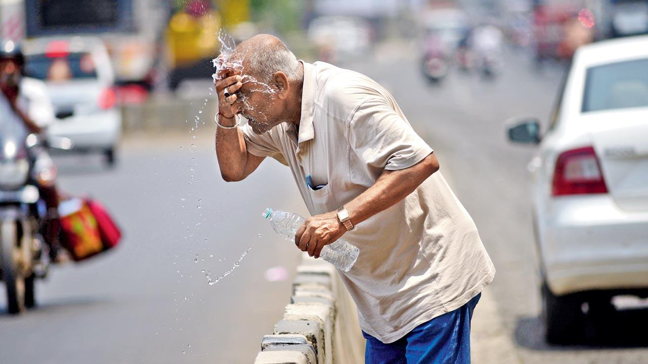 A Mumbaikar splashes water on his face to get relief from the extreme heat. The city recorded its hottest day this year in the first week of March at 39.3 degrees Celsius, six degrees above normal. Pic/Pradeep Dhivar