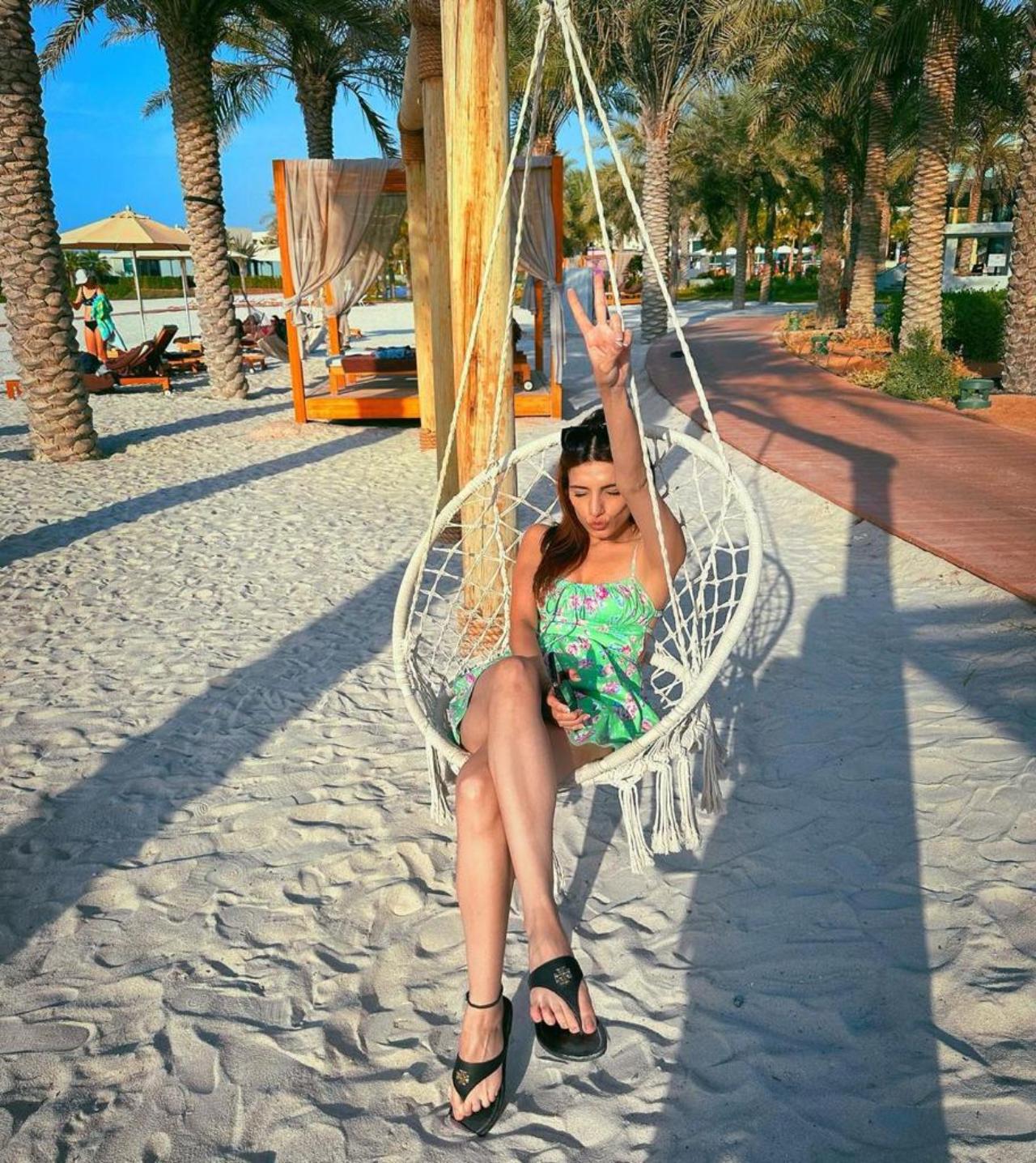 Prakriti Kakkar looks absolutely stunning in her green summer dress as she relaxes on a hammock chair on the beach. The vibrant green colour of the dress adds a pop of energy and liveliness to the scene, making it clear that Prakriti is here to have a good time and enjoy the carefree summer days.
 