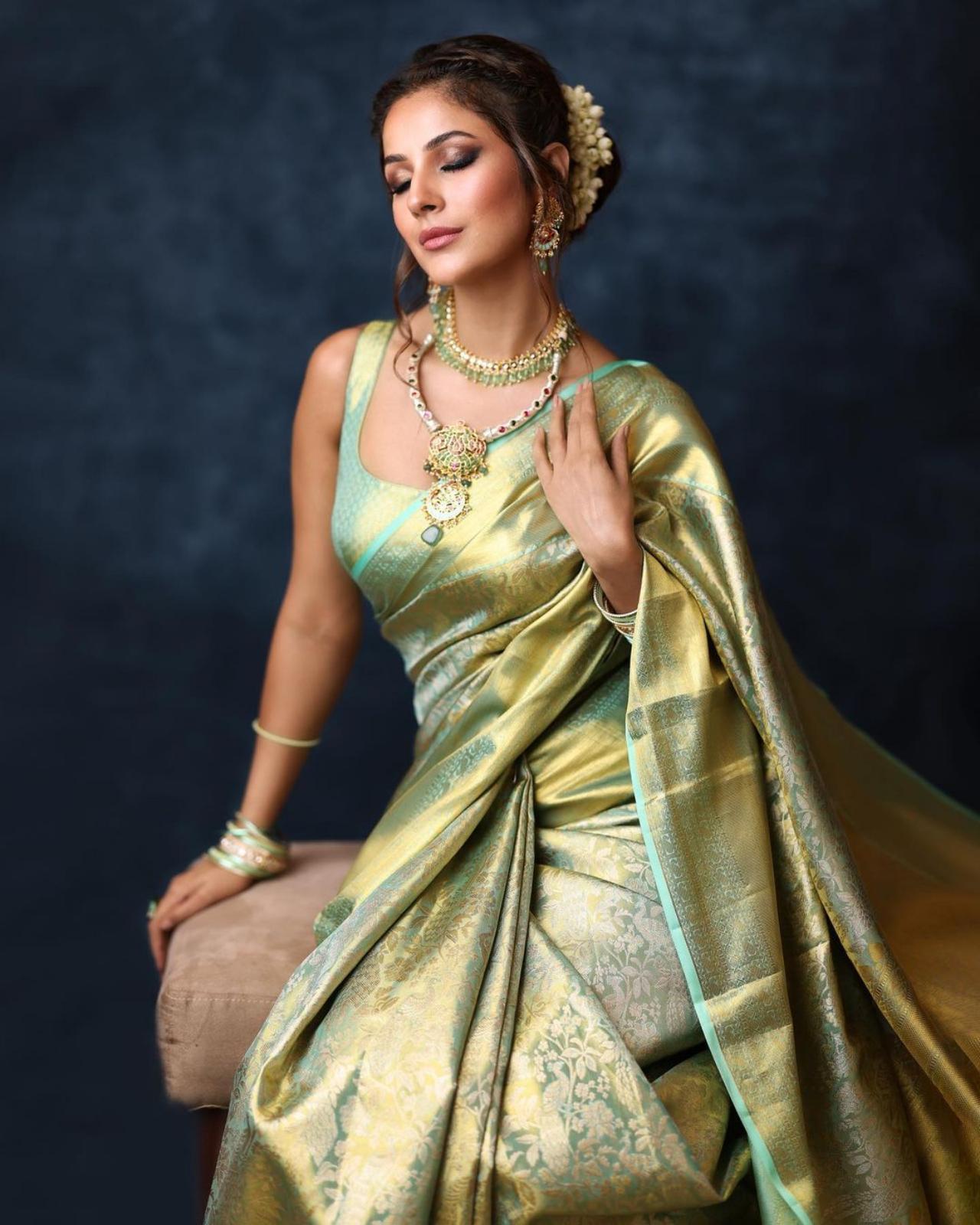 Bringing another ethnic look to the table, this time Shehnaaz slipped into a beautiful mint green Kanjivaram saree with undertones of gold. For the hair, Shehnaaz opted for a low bun decorated with flowers.  