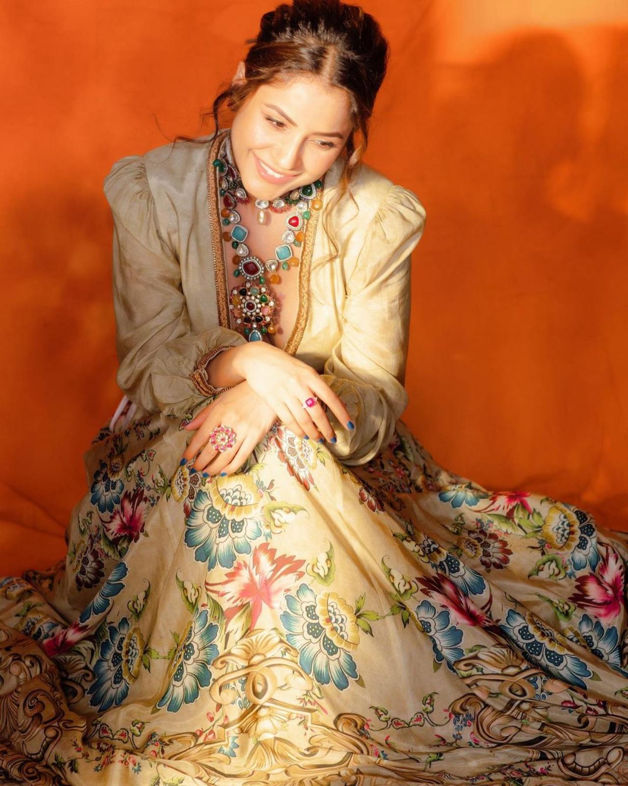 Yet another ethnic look, Shehnaaz slipped into a printed lehenga paired with a beige blouse featuring puffy sleeves. The look was topped off with a stunning statement necklace embellished with colourful stones.