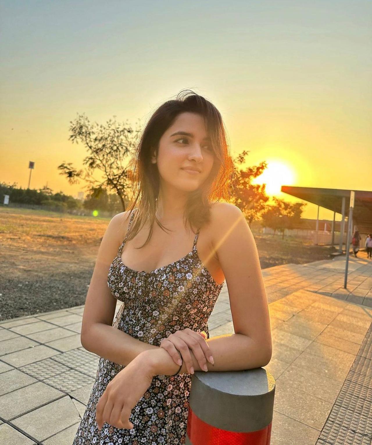 This golden hour look is absolutely gorgeous on stunner Shirley Setia. Shirley wears a floral minidress and keeps her hair and makeup super casual. With the sun gleaming from behind her, this picture is giving us major fashion goals to beat the summer heat.
 