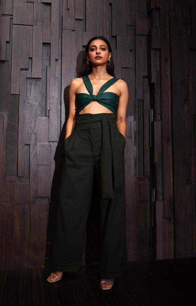 Radhika Apte looks stunning in an emerald green tie-up bikini top paired with olive-green wide-leg paper bag tie-up pants.