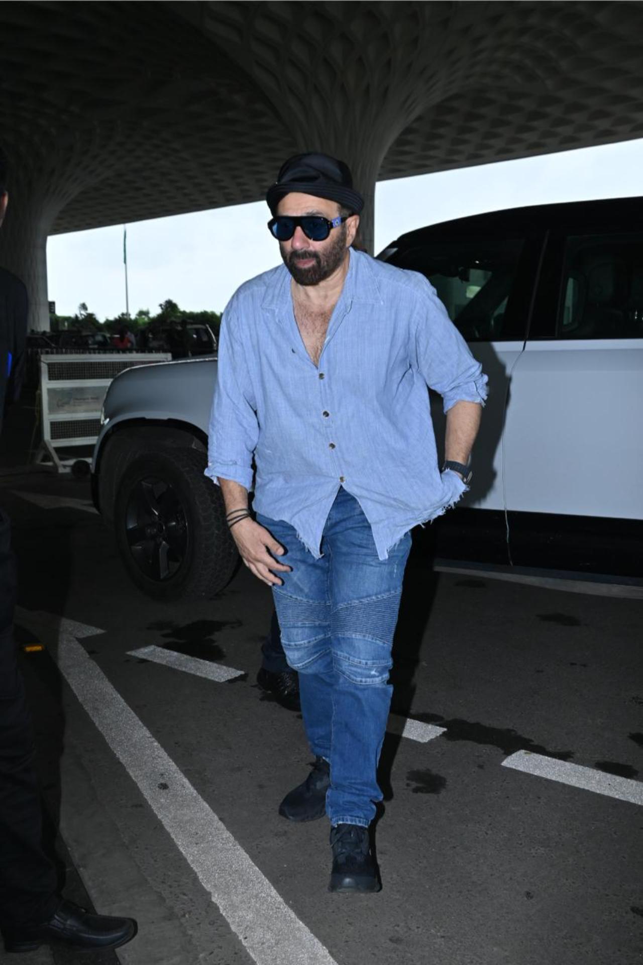 Sunny Deol was also captured getting out of his car at the Mumbai airport today. He wore a casual, laid-back fit comprising blue shirt, denim jeans and a hat