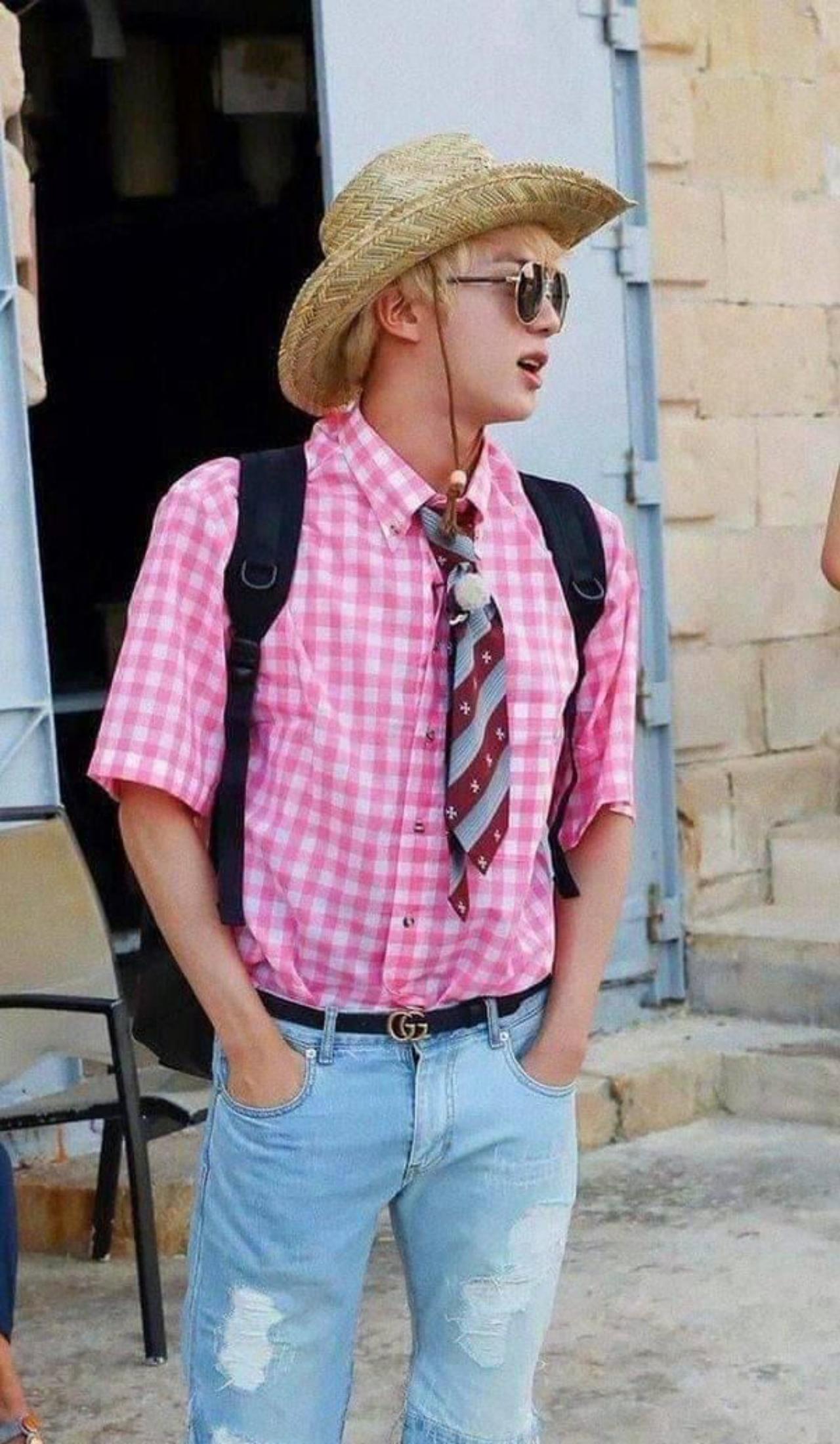Jin is the maestro of putting together the most eclectic ensembles. During BTS's Malta trip, Jin paired a formal pink checkered shirt with a tie, a hat and a pair of jean shorts (made DIY style by cutting - yes you heard that right - a pair of perfectly good jeans). No wonder J-Hope was a little embarrassed of him