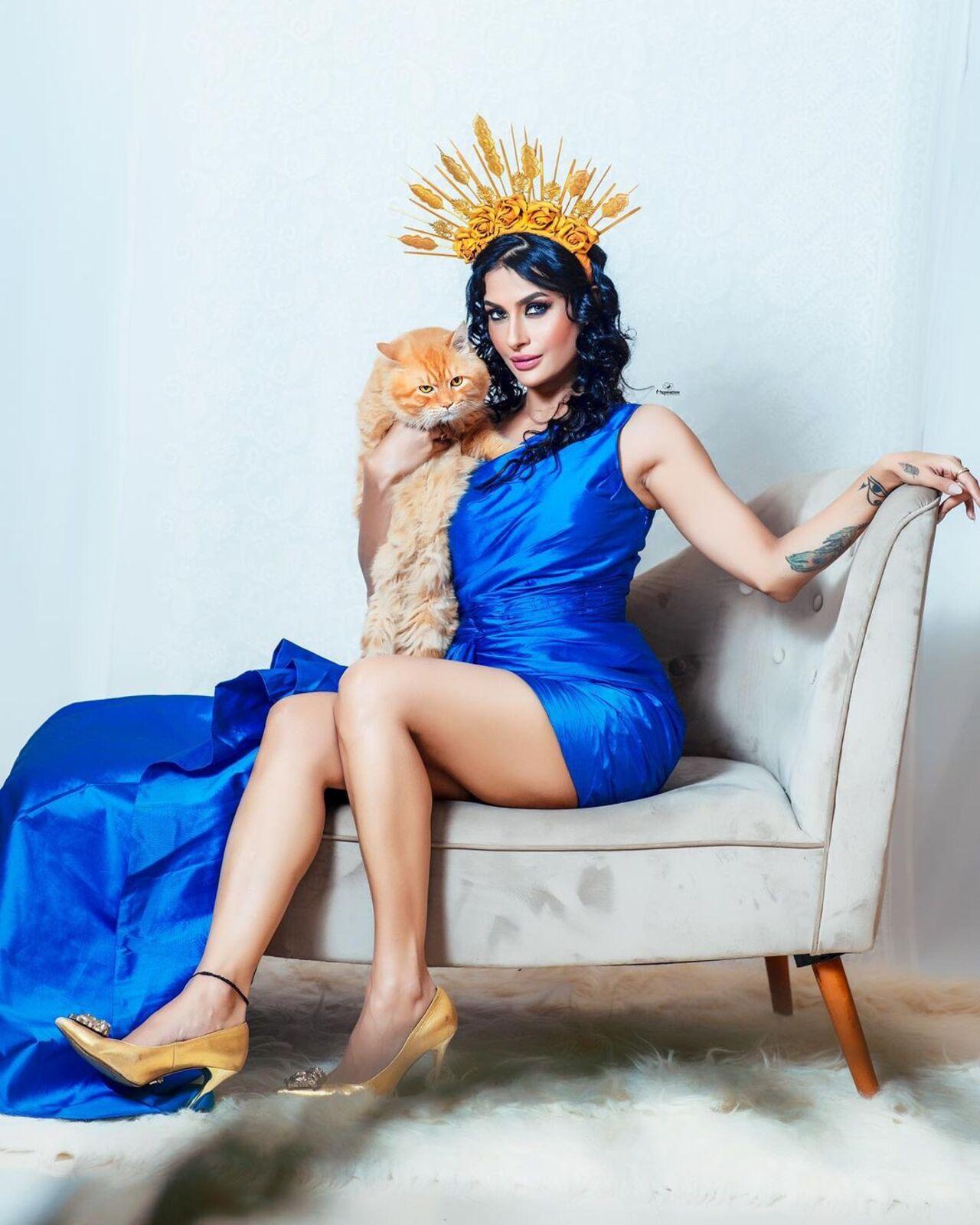 Pavitra Punia accessorised her blue dress with an intricate crown. The actress posed with a cat which elevated her fiery look