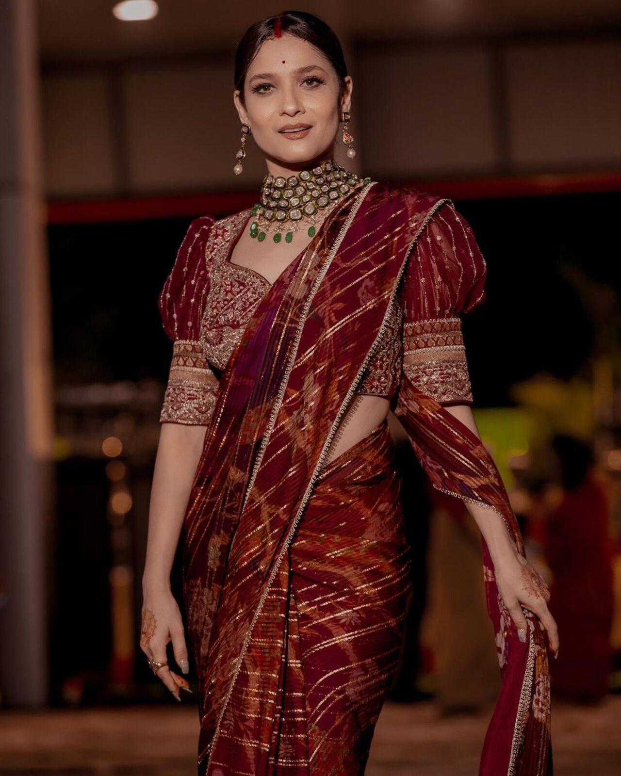 Ankita Lokhande opted for a stunning maroon-coloured saree and paired it with a heavy blouse. The puffed sleeves of the blouse elevated her entire look