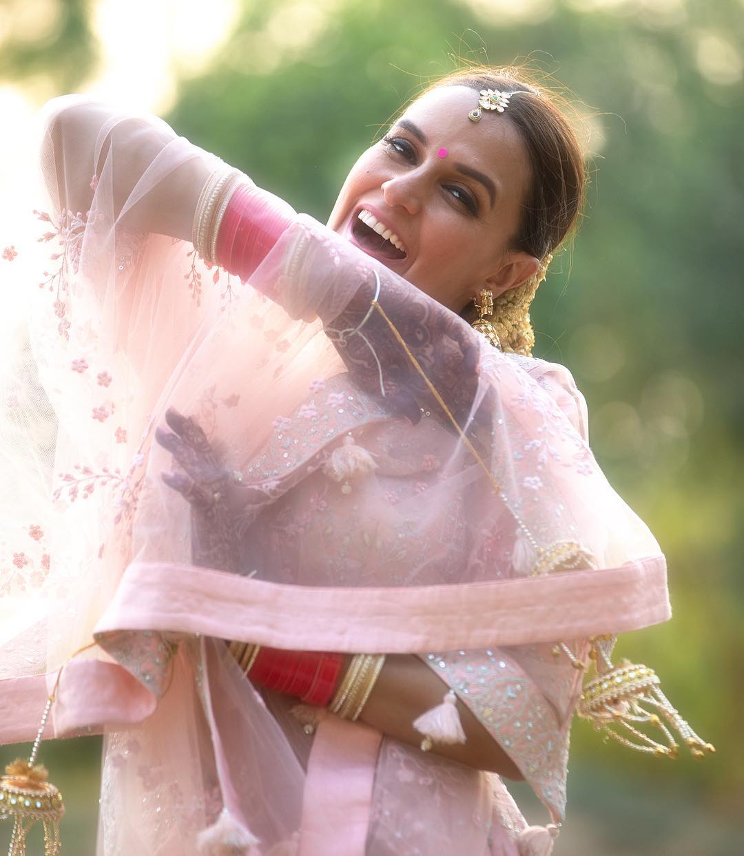 Staying true to her 'less is more' aesthetic, the bride made a distinct choice by opting for a blush pink lehenga, perfectly aligned with the daytime occasion. 