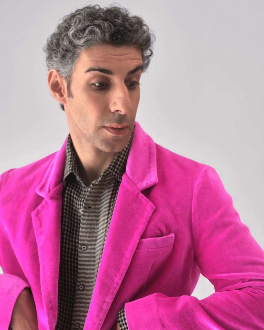 Jim Sarbh embraces a captivating contrast in his ensemble, pairing a striking pink coat with pinstriped black and white pants. The combination of bold and subtle elements creates a visually appealing balance, showcasing his keen sense of style.