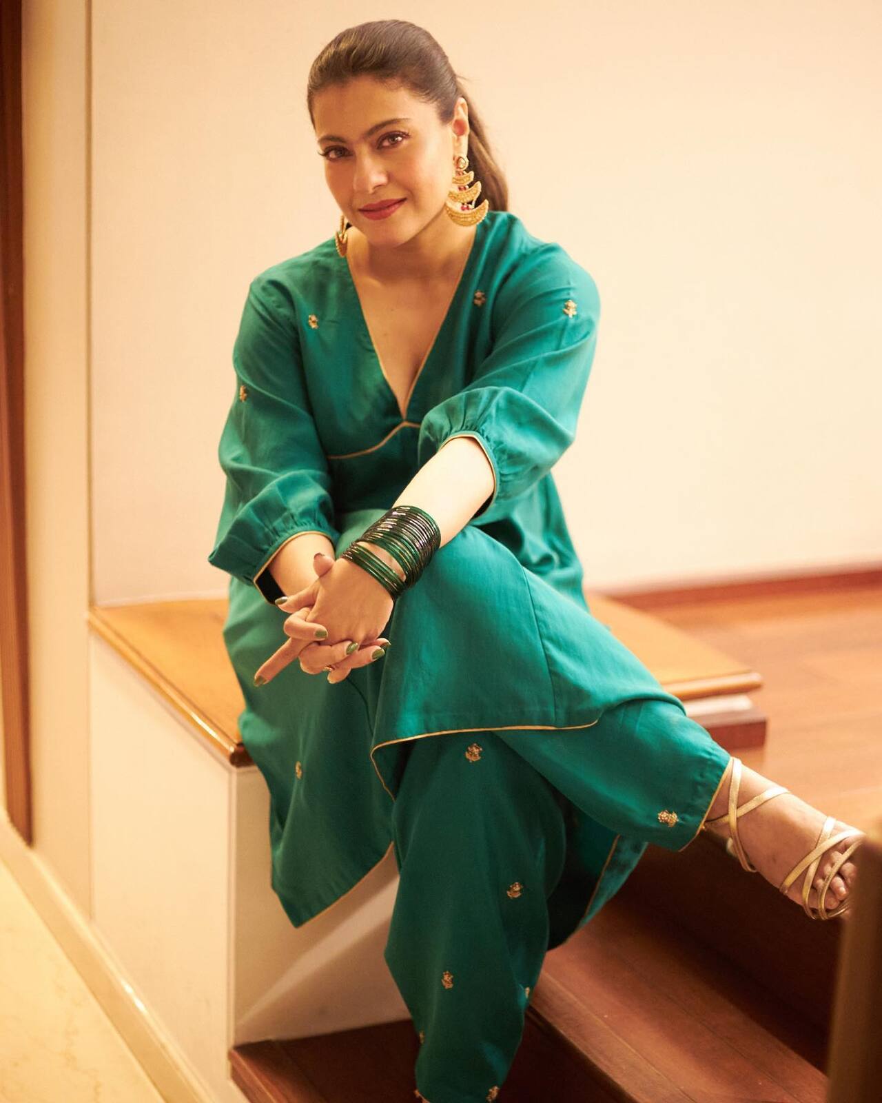 Kajol picked a green salwar with a plunging neckline, quarter sleeves, minimal embroidery work in golden resham threads and embroidered gold borderns.The salwar also featured corset details, and Kajol paired it with matching trousers and gold jewellery. Doesn't she look like a goddess of the forest? With the pictures, the actress wrote, “Which vegetable am I? Can’t make up my mind…Bhindi or Methi?” Well whichever vegetable she may be, she is definitely serving up some style inspiration for Teej!