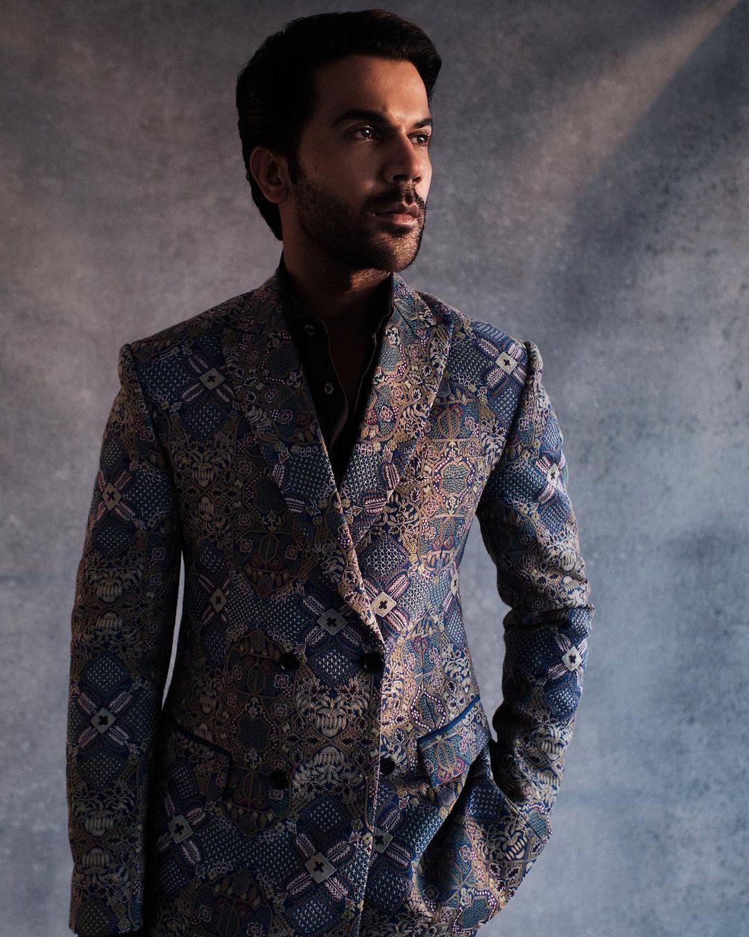 A highlight of his ensemble is the blazer he dons, a captivating piece that balances intricate geometric patterns with delicate floral motifs.