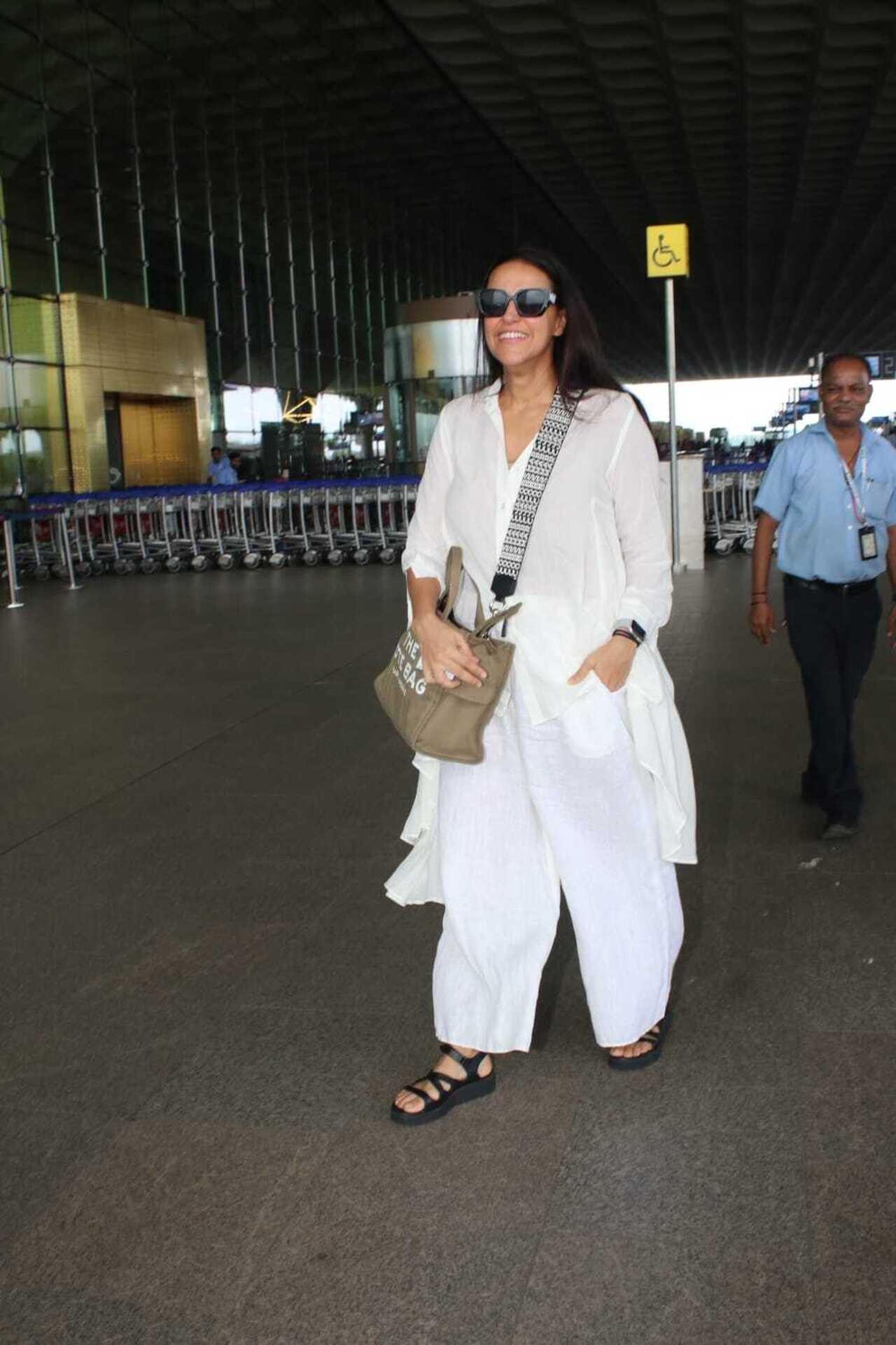 Neha Dhupia looked stunning as she chose an all-white outfit for her airport look