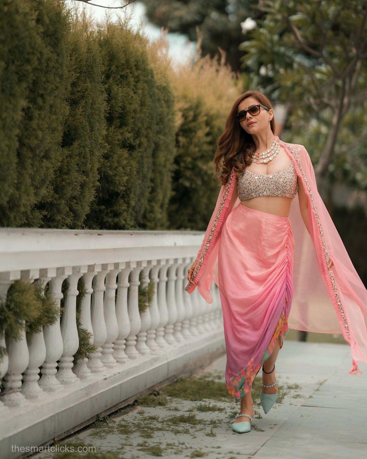 Rubina wore a stunning Indo-western dress by Label PS'B. The actress styled the pink dhoti with a heavily embroidered blouse complimented by a matching cape. The actress kept her hair open in loose curls. The contrasting green sandals broke the monotony 