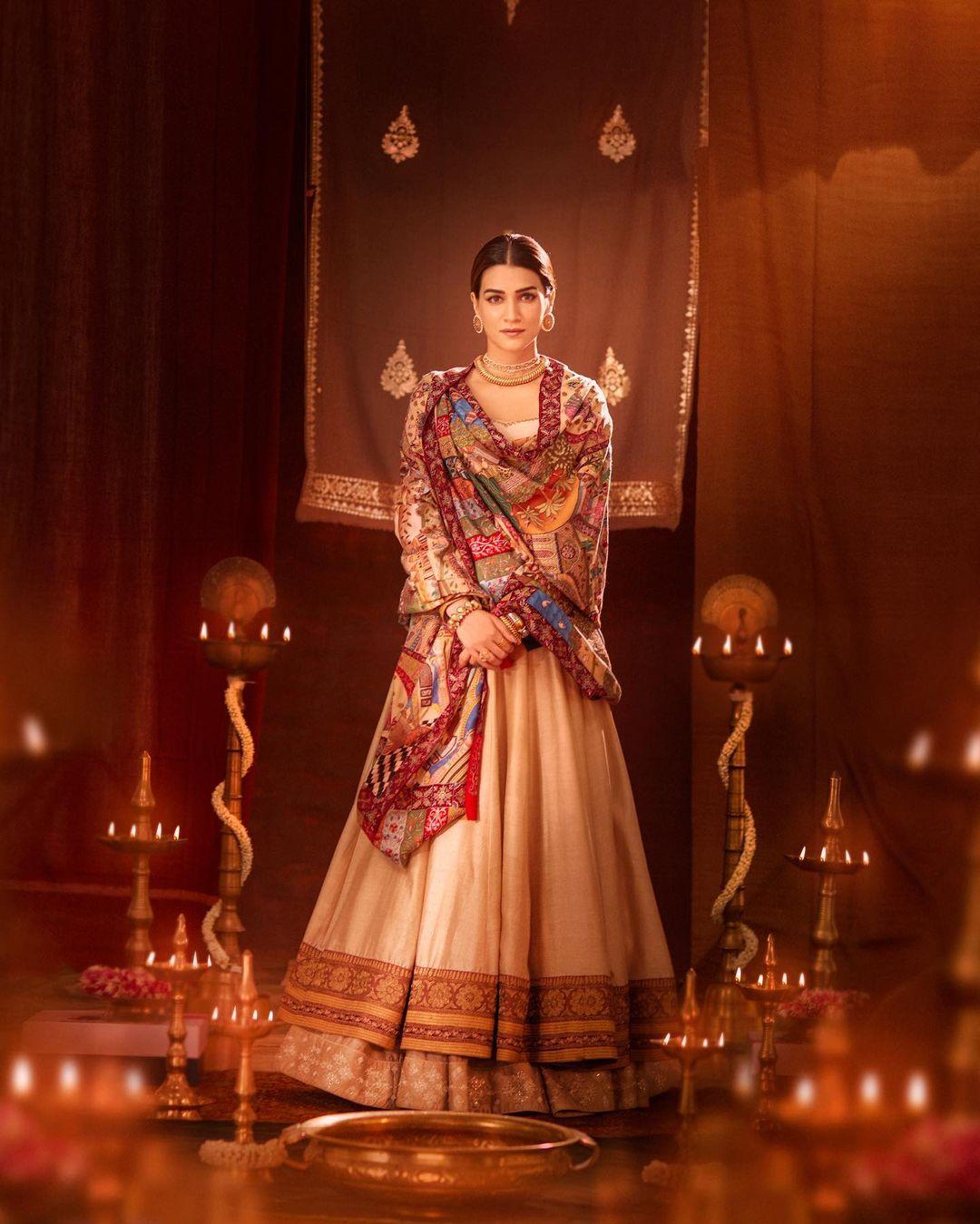 Kriti casts a spell in a custom-made beige lehenga suit crafted by Sukriti and Akriti Grover. The ensemble is a dreamy fusion of tradition and modernity, boasting an anarkali top paired meticulously with a lehenga and a dupatta adorned with a rustic pink border.