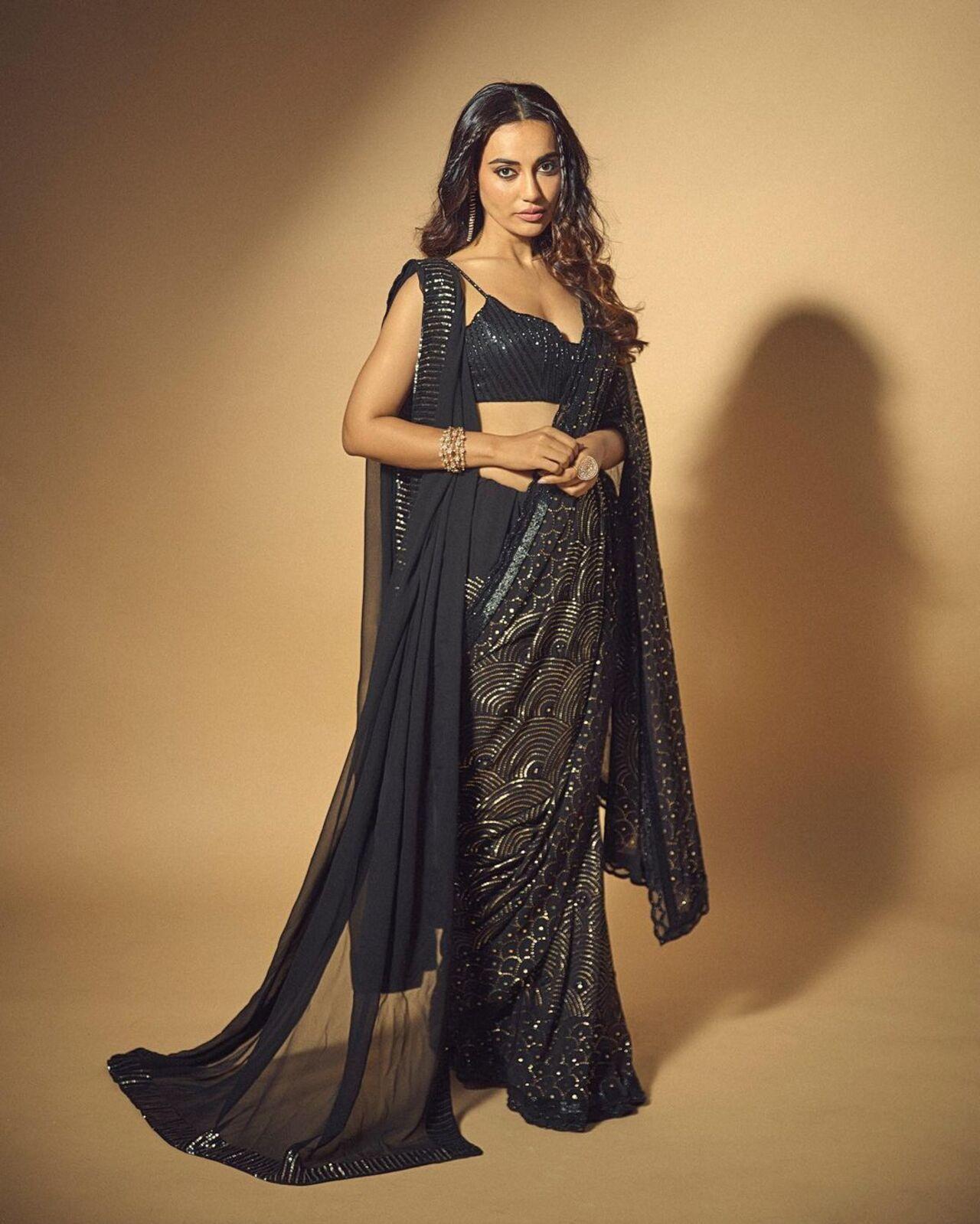 Surbhi Jyoti looked stunning in a black sequin saree complemented by a deep-neck matching blouse