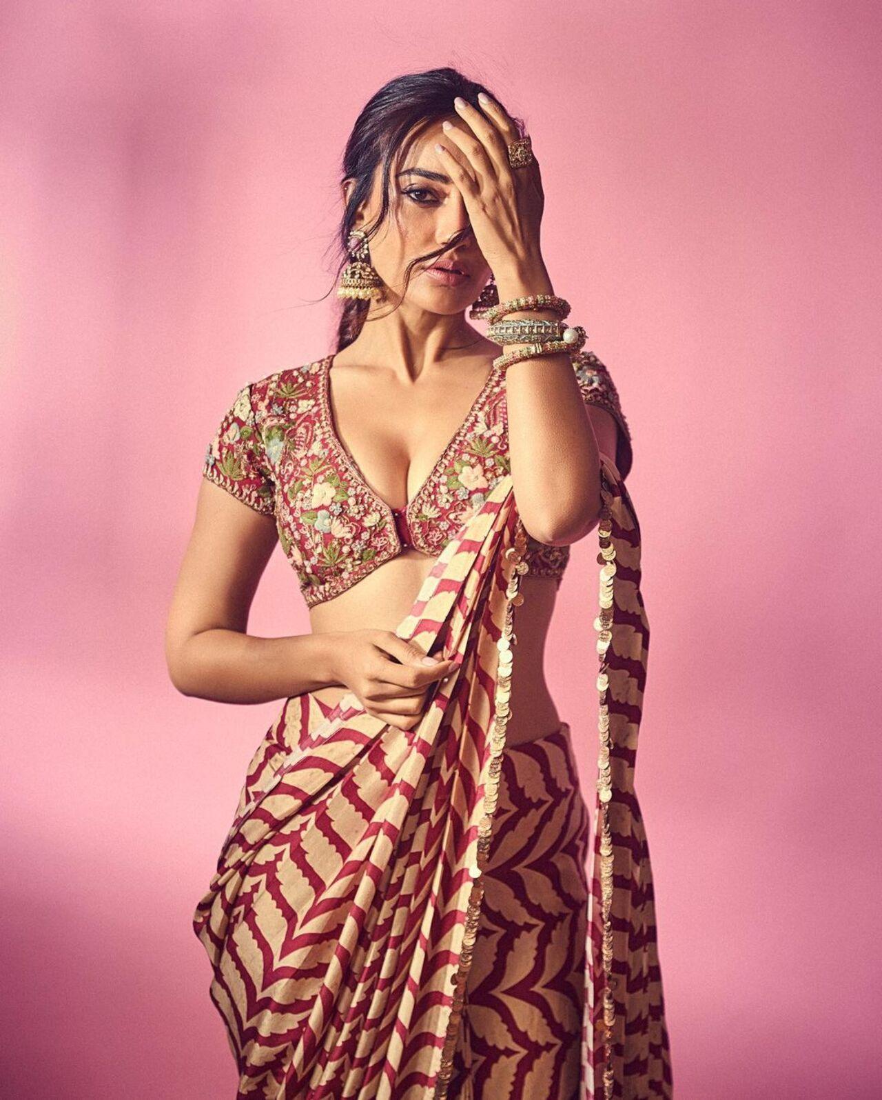 In this picture, Surbhi Jyoti donned an elegant look in a plain zigzag pattern saree paired with a richly embroidered blouse