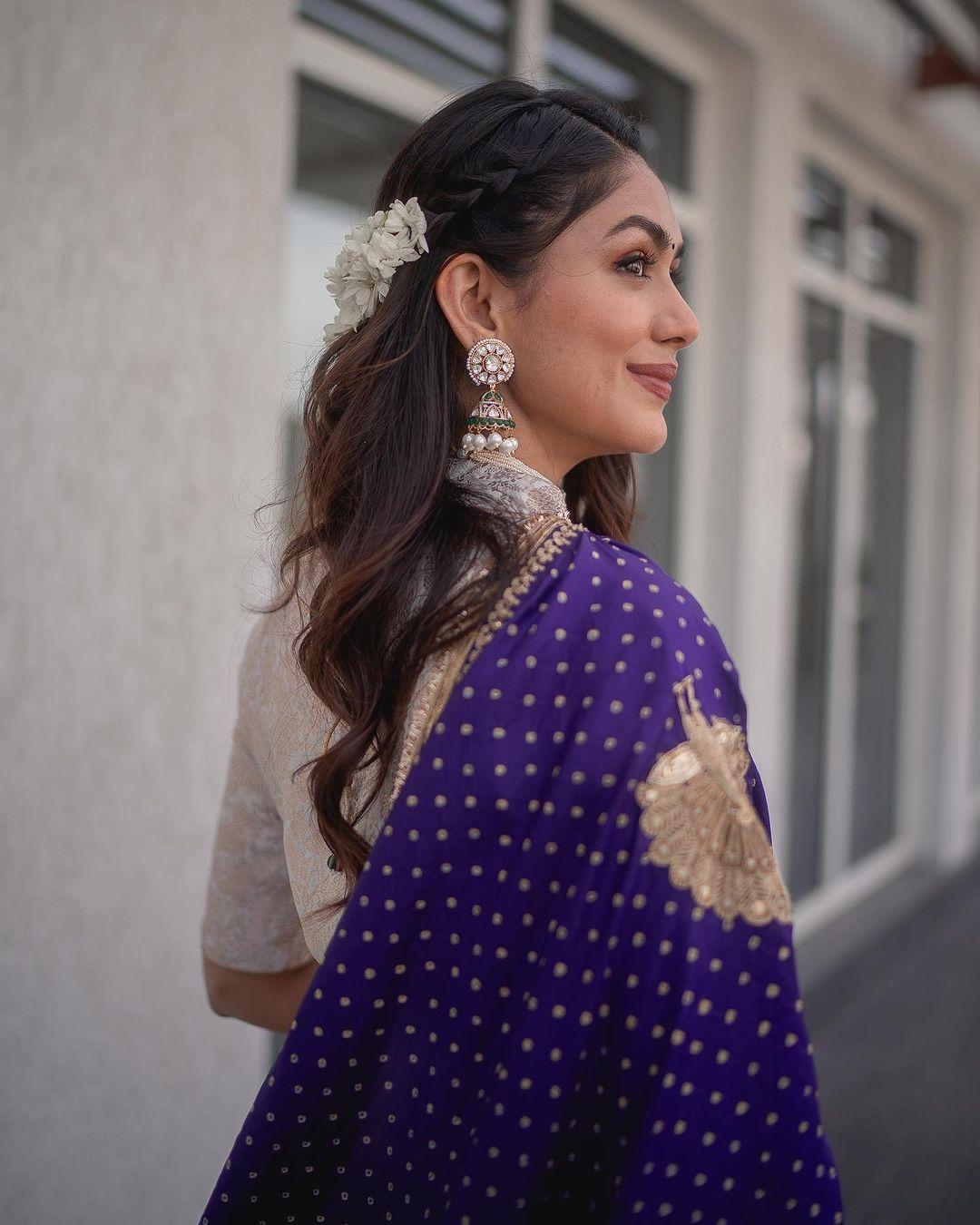 Mrunal shines as a beacon of style in a pastel brocade gown from Raw Mango. This ensemble flawlessly merges tradition and modernity, featuring palazzo pants and a short-sleeved kurti with a daring neckline.