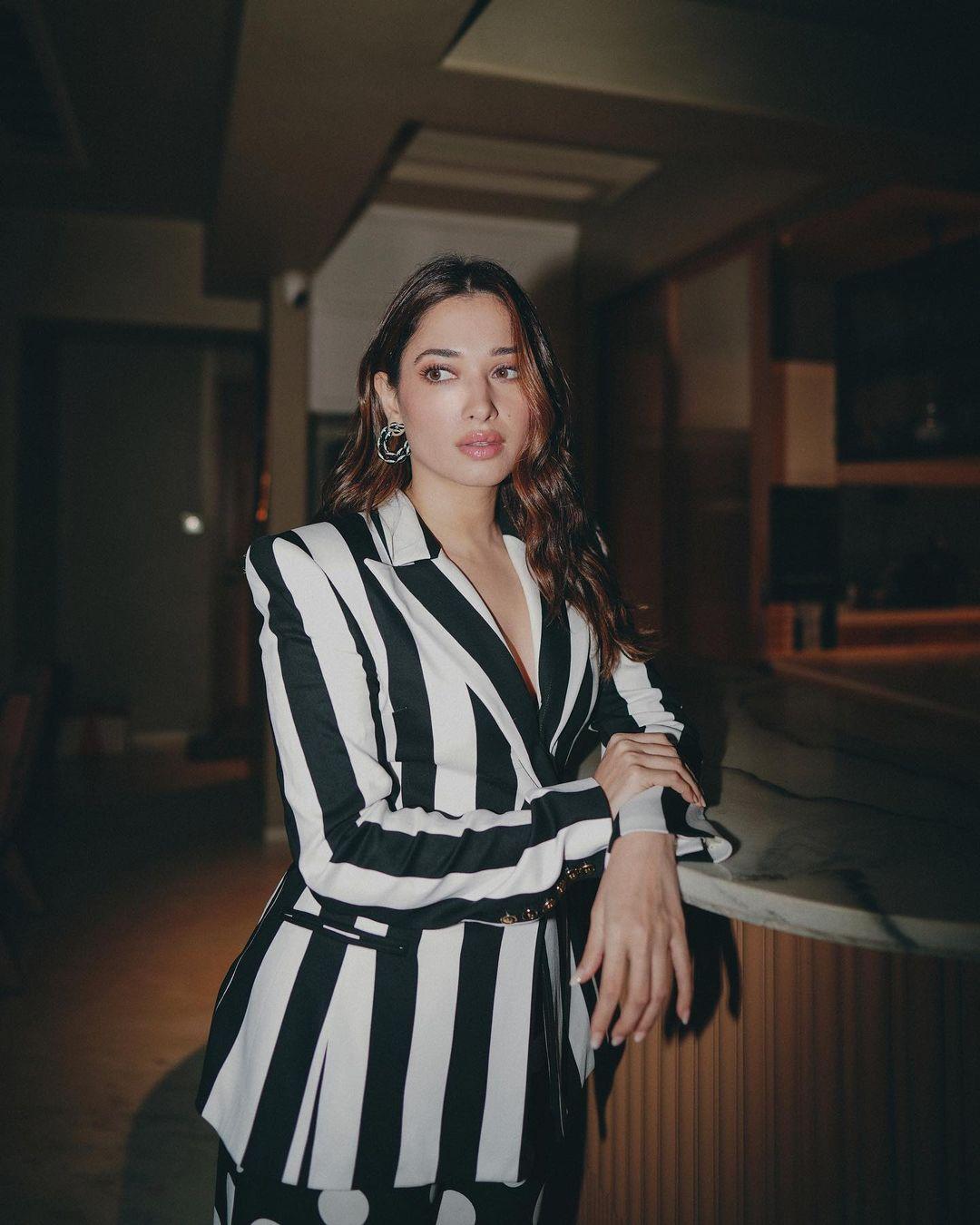 Embracing the charm of a well-executed printed ensemble is a shared delight. Tamannaah, however, takes this fondness to the next level, setting an exemplary benchmark with her black and white power suit