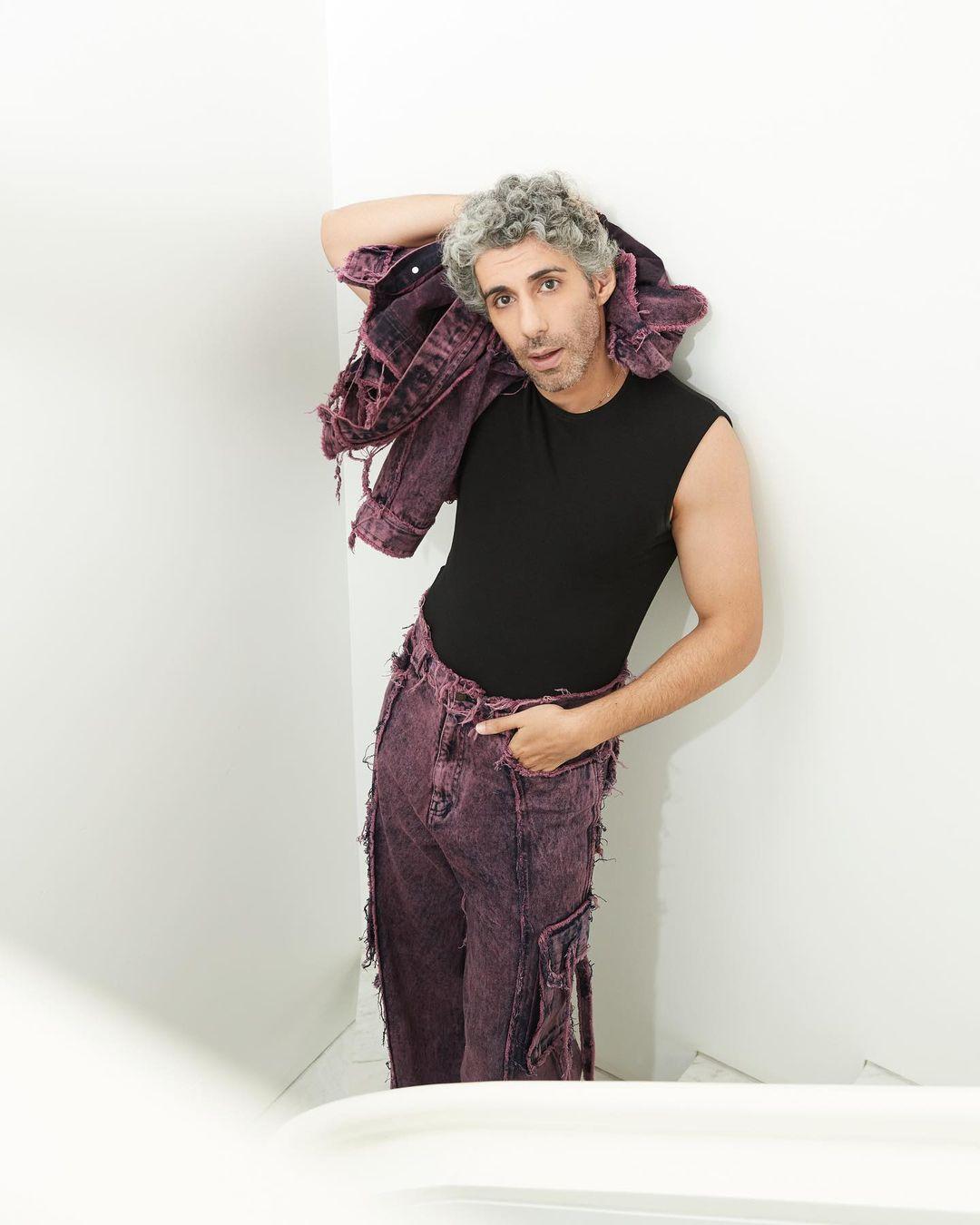 Jim Sarbh showcases his bold fashion sense in a striking outfit that combines hues of purple and black. The actor dons a dapper black top, which serves as a versatile foundation for his ensemble. Adding a pop of color, he confidently pairs the top with vibrant purple pants that make a statement on their own. 