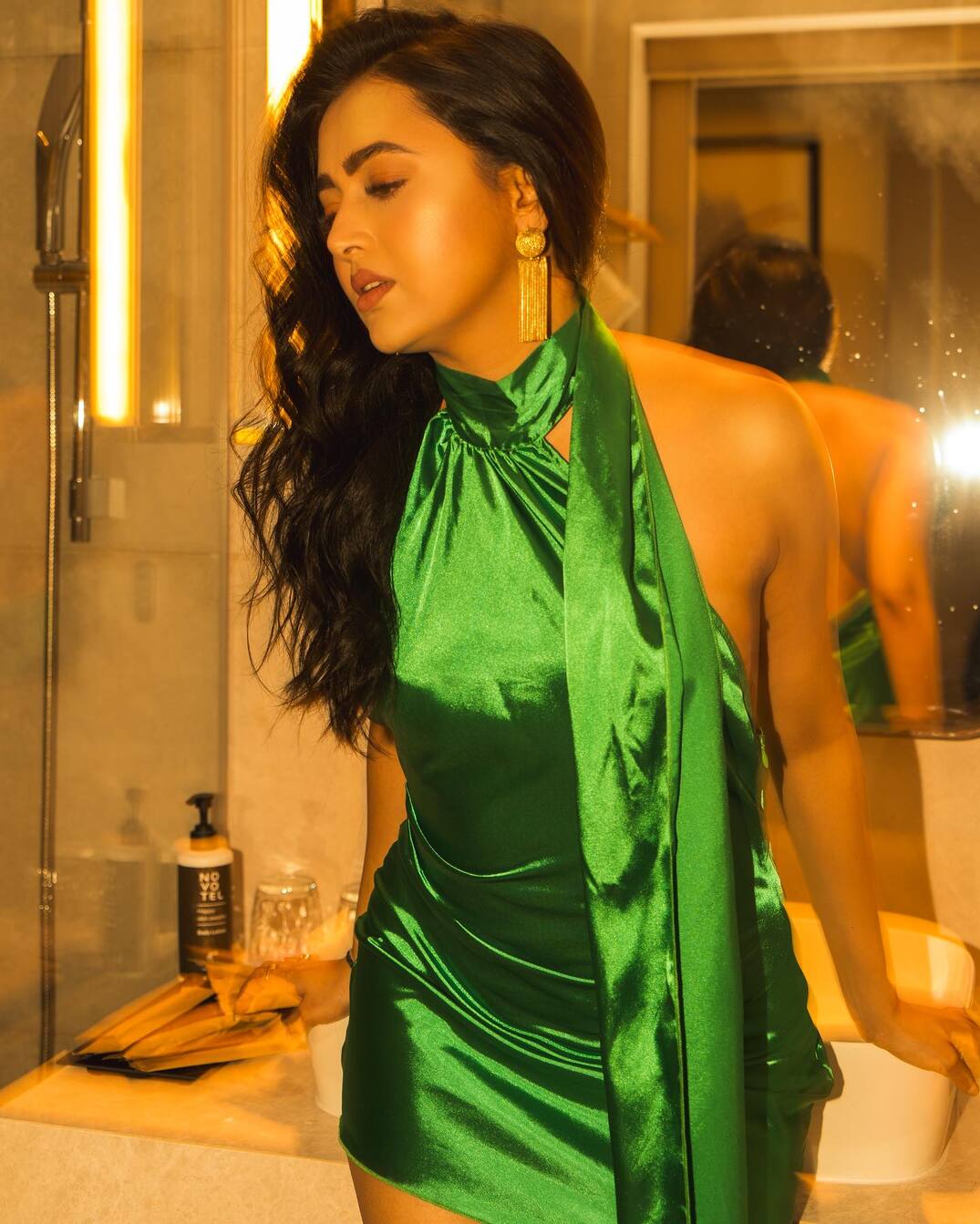 For this look, Tejasswi Prakash opted for a stunning green dress. The talented actress paired the stunning dress with contrasting golden earrings