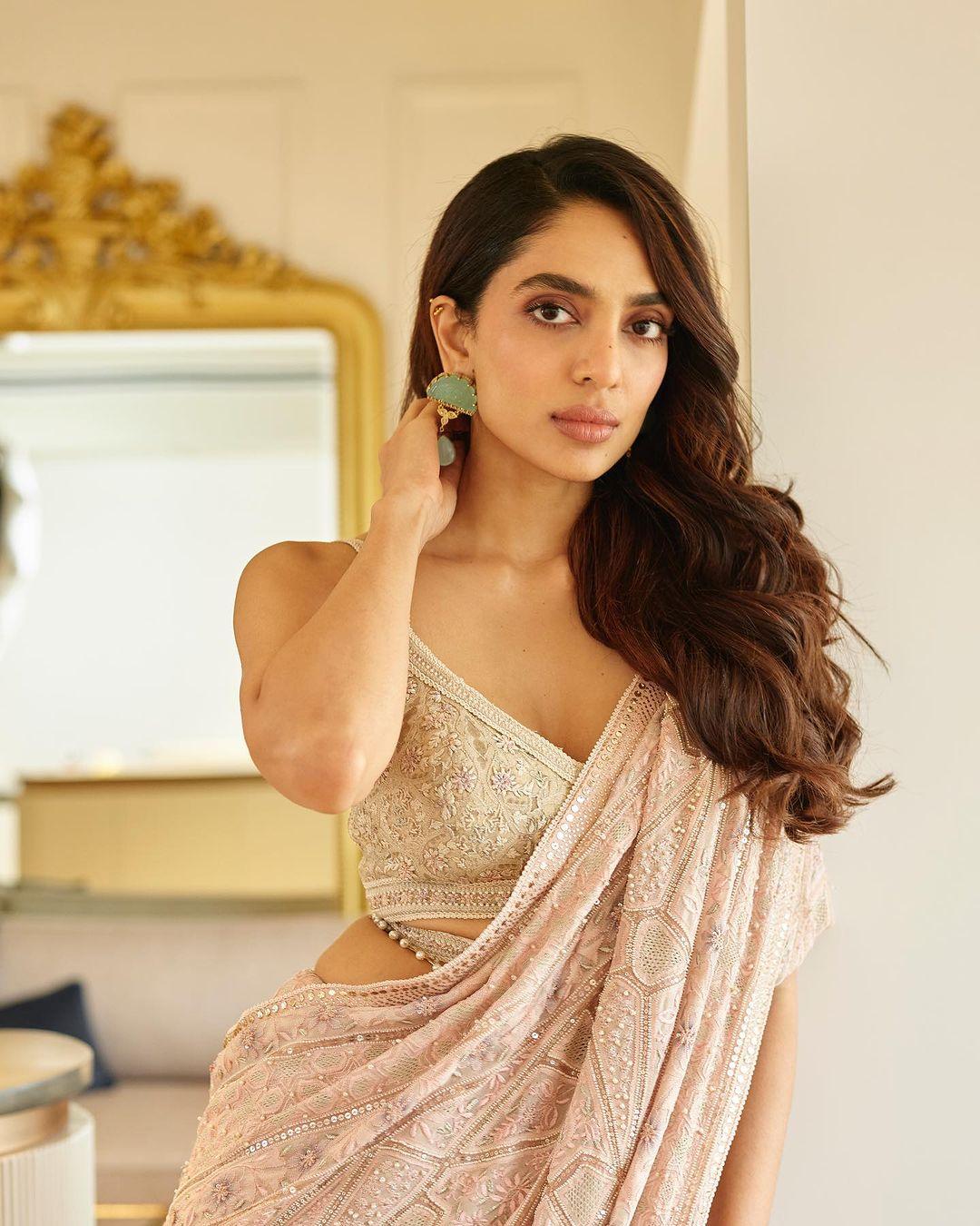 The rose gold hue added a touch of opulence to her look, while the intricate detailing on the saree reflected her keen eye for style.