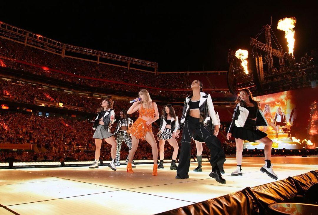 Taylor Swift delivered an unforgettable spectacle for her fans, gracing the stage in an orange shimmering two-piece ensemble designed by Roberto Cavalli. This outfit epitomized the essence of a party, radiating a vibrant energy that was as captivating as it was celebratory. The exquisite design of the ensemble created a mesmerizing illusion of crystal water droplets, each seemingly in motion as she commanded the stage with her performance. Her choice to pair the ensemble with her signature sequin Christian Louboutin boots added a touch of edgy glamor, perfectly complementing the ensemble's vivacious spirit. With this look, Taylor Swift once again demonstrated her prowess not only as a musical artist but also as a true fashion icon, leaving a lasting impression on all who witnessed her electric performance.
