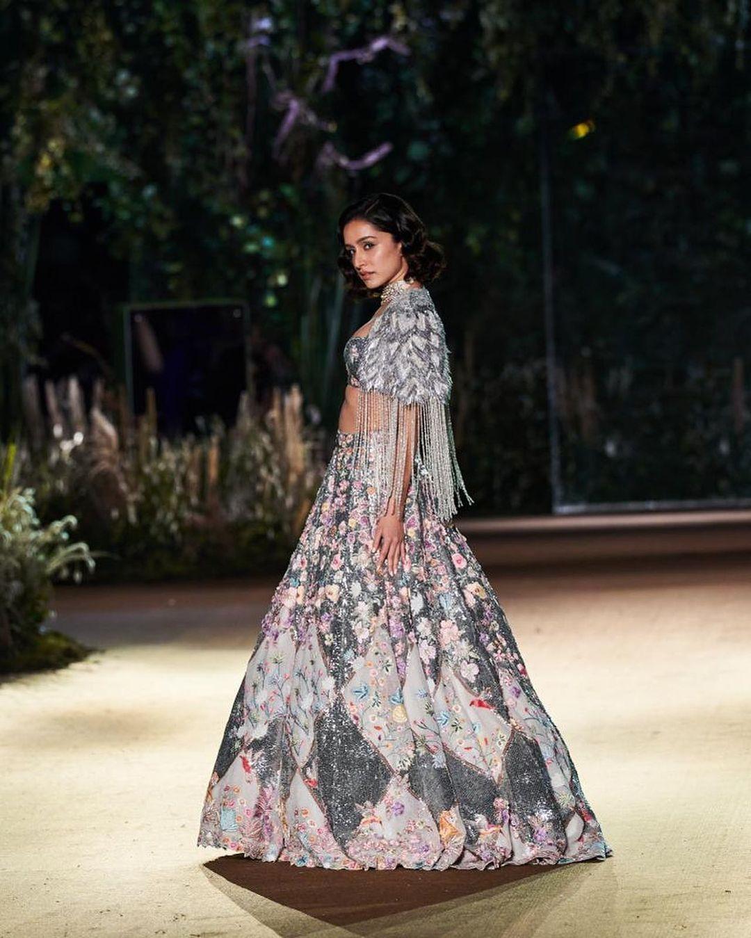 The show's highlight was an exquisite silver glittery lehenga, elegantly paired with a tassel crop jacket adorned with the designer's distinct sequin detailing.
