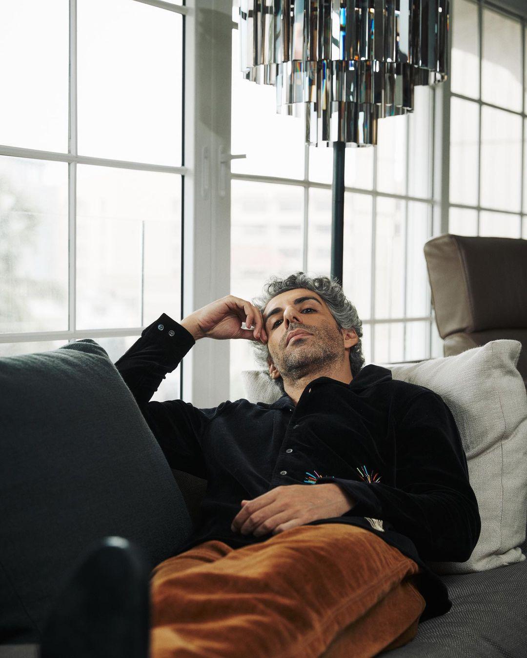 Paired with this statement piece, he opts for brown pants that complement the jacket perfectly. 